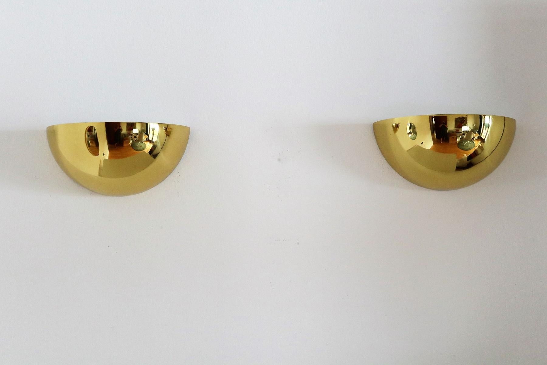 Gorgeous large pair of wall sconces in the shape of half moon, made of solid polished brass.
Made in Germany in the 1960s approx.
Internally varnished in white.
Each with one ceramic Edison bulb holder.
Very good vintage condition with normal patina