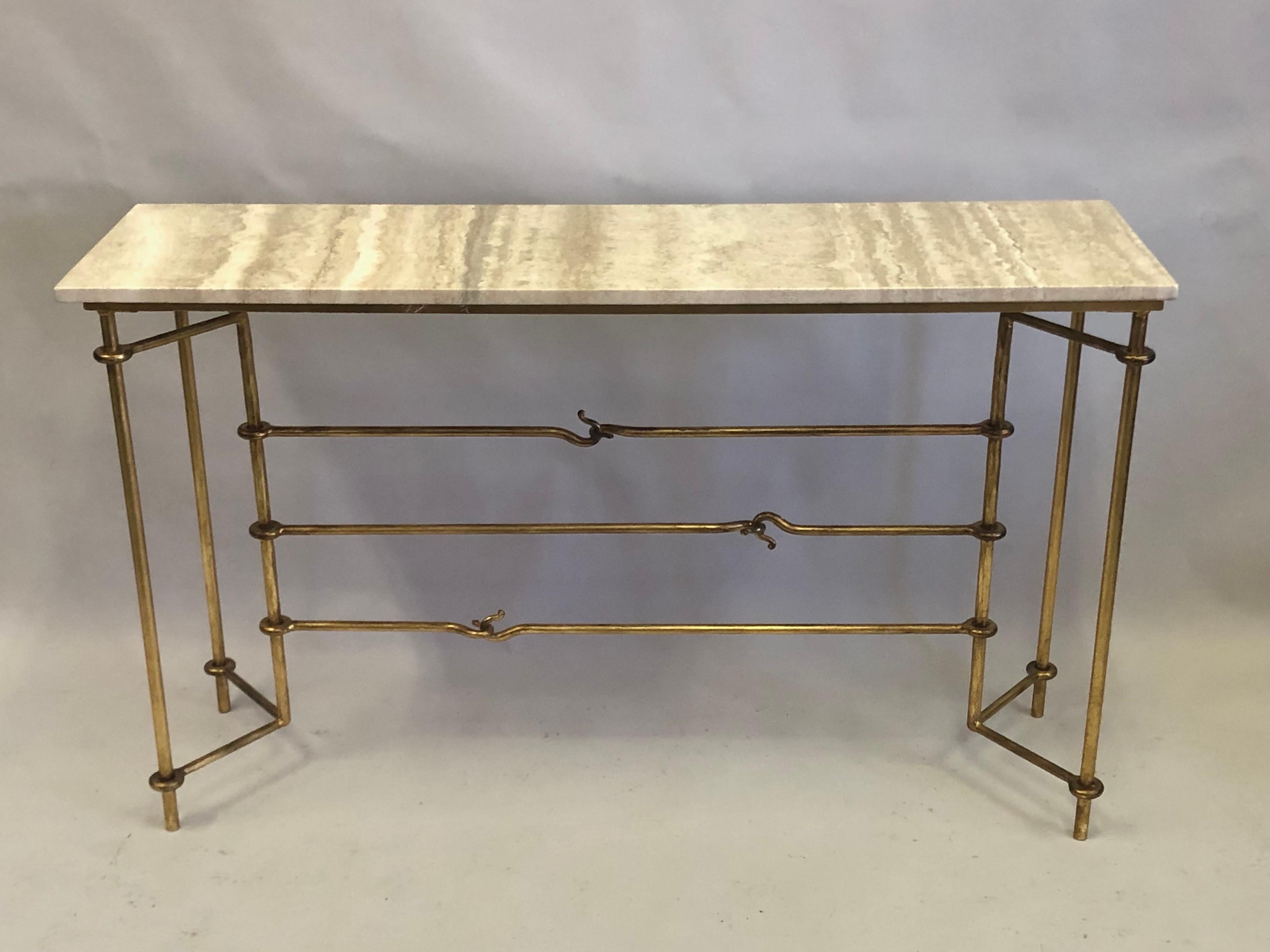 Exquisite Italian Modern neoclassical console in classic Hermes styling featuring horse hardware motifs. The console / sofa table is in hand hammered and gilt iron by Giovanni Banci for Hermes. The top is in Roman travertine. 

Dimensions: H 32 x