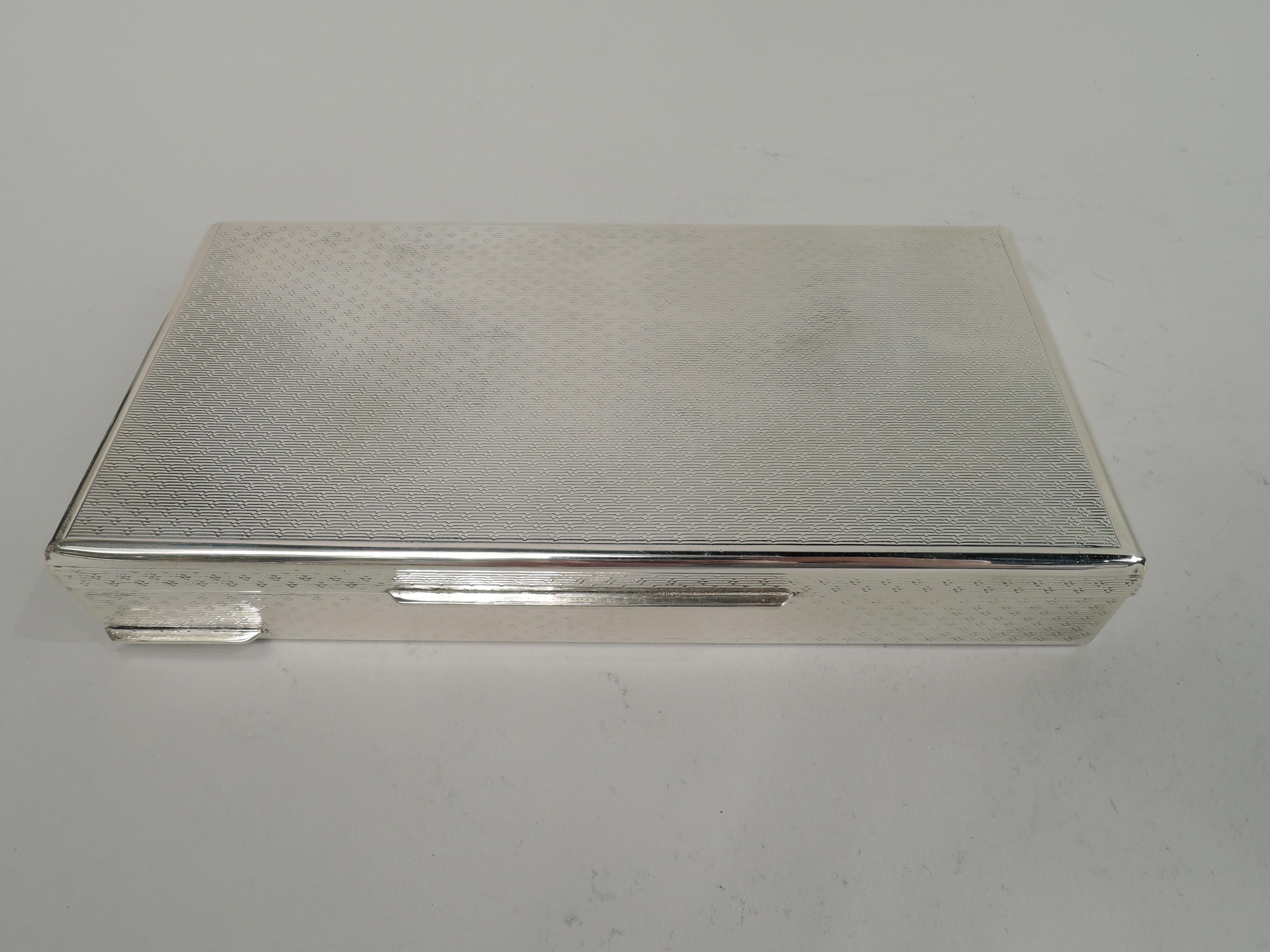 Italian Mid-Century Modern 800 silver box. Rectangular with straight sides and thumb rest. Cover flat and hinged with tab. Allover engine-turned curvilinear ornament in plain borders on sides and cover top. Box underside plain. Marked “800” and
