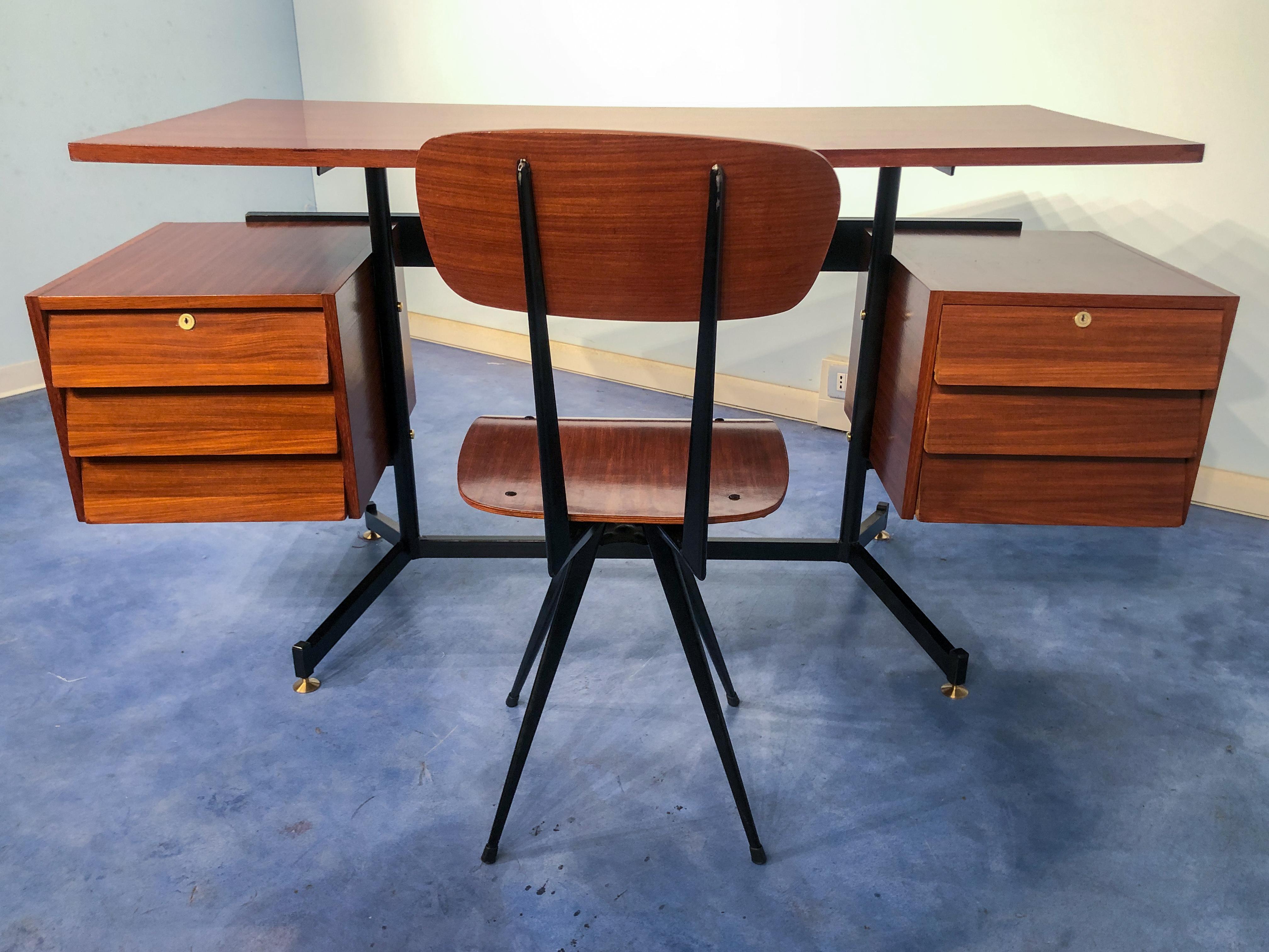 Stylish Italian Mid-Century Modern desk features quality teak construction with a perfectly matching chair.
Floating top design, very beautiful line, jutting drawers, black metal frame with brass feet. The chair has a very nice design with