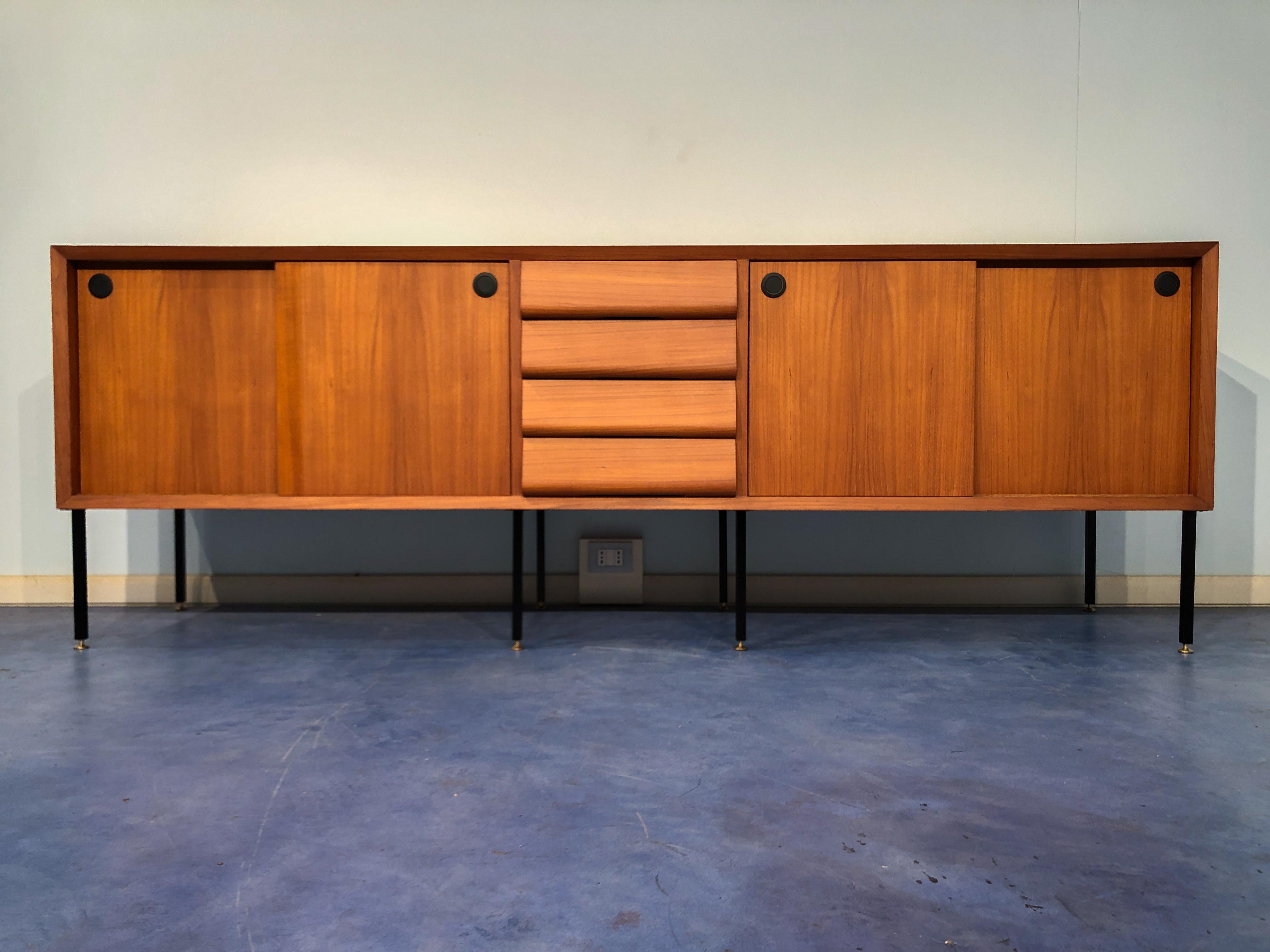 Beautiful Italian Mid-Century Modern teak set with the sideboard, round table, and two chairs.