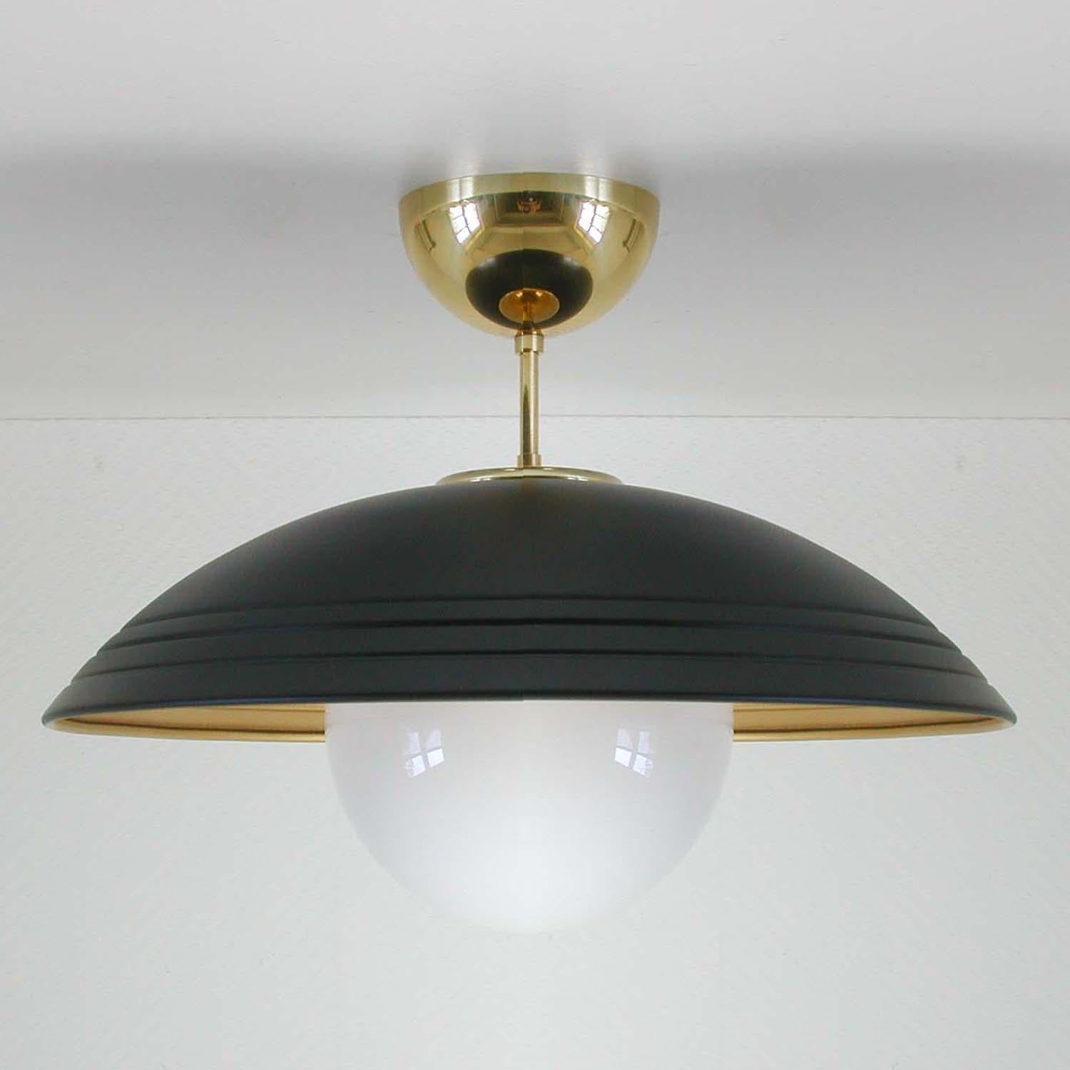 This semi flush mount was made in Italy in the late 1960s, early 1970s. It has got a black lacquered and gilt colored metal lamp shade, white opaline glass globe and brass details.

The light requires one E14 bulb.

Rewired for use in US.