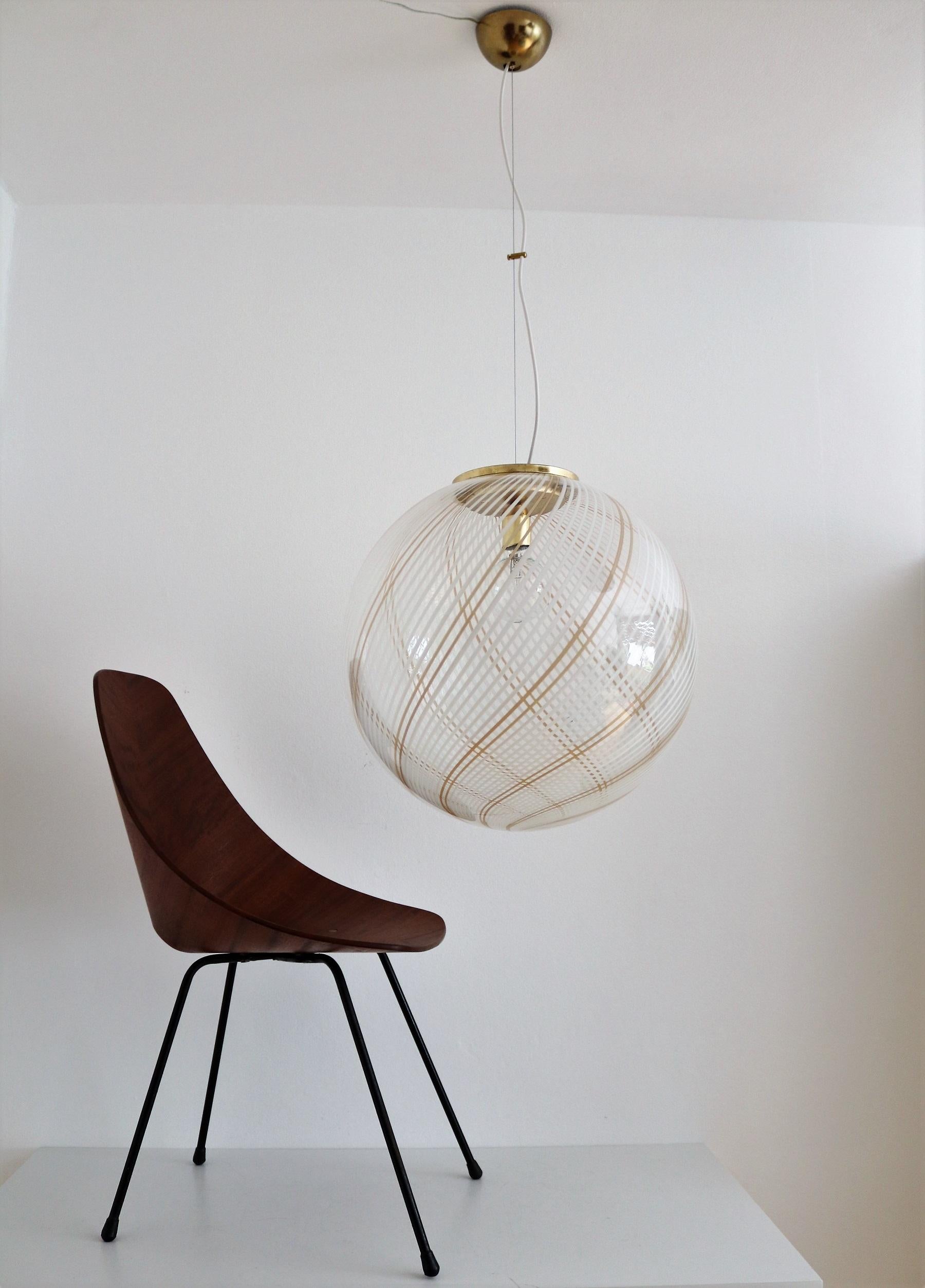 Beautiful and big elegant Murano glass globe pendant lamp with gilt metal details.
The diameter of the glass is 50cm / 20inches! 
The drop height is actually 120cm (47,2in), adjustable.
Made in Murano, Italy in the 1970s.
The lamp leaves