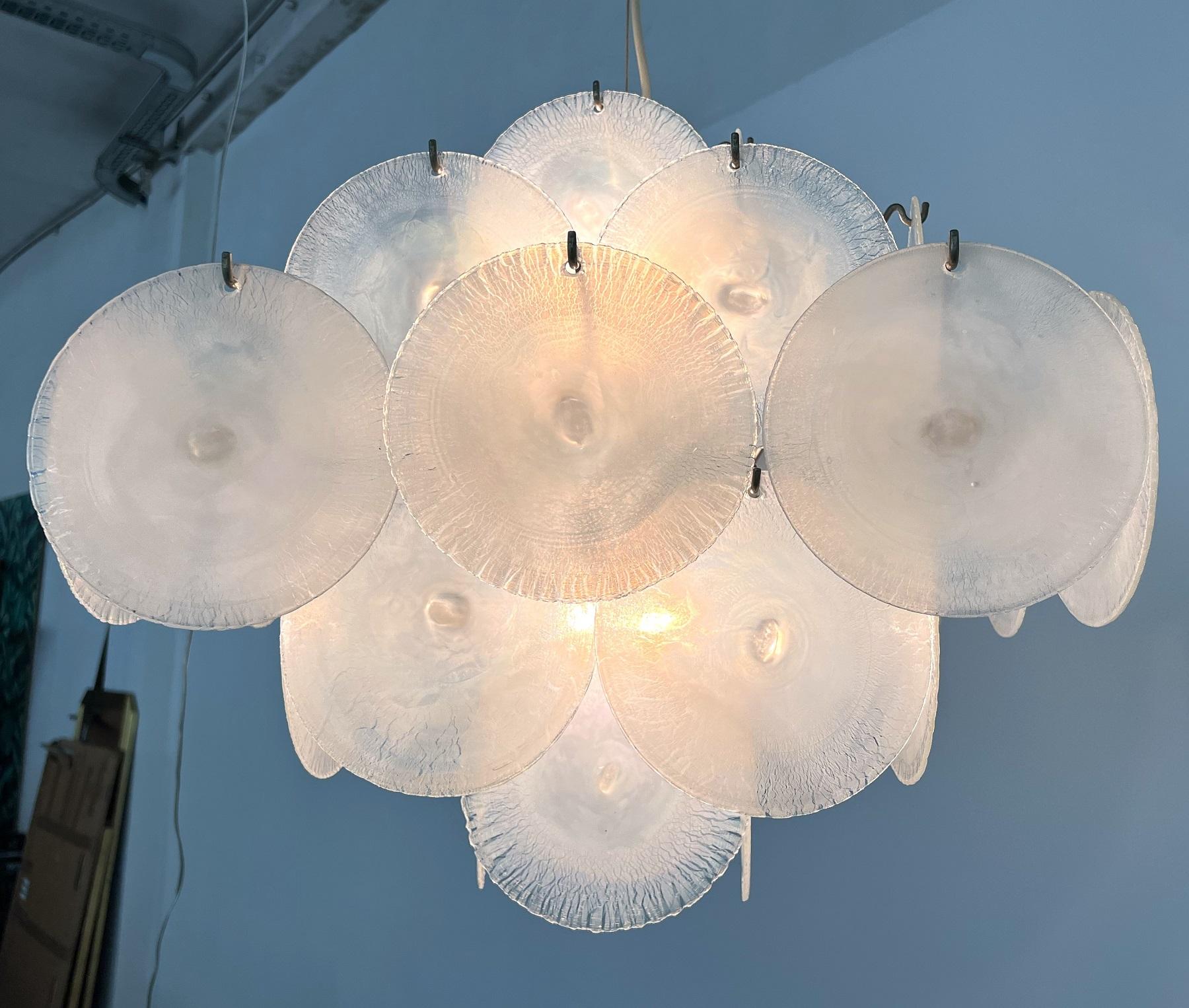 Magnificent, original vintage chandelier designed from Carlo Nason and manufactured in Murano from Mazzega in the 1970s.
This chandelier is made of s solid lamp's base in nickel with 36 hooks and the matching ceiling rose, hold from a steel cable