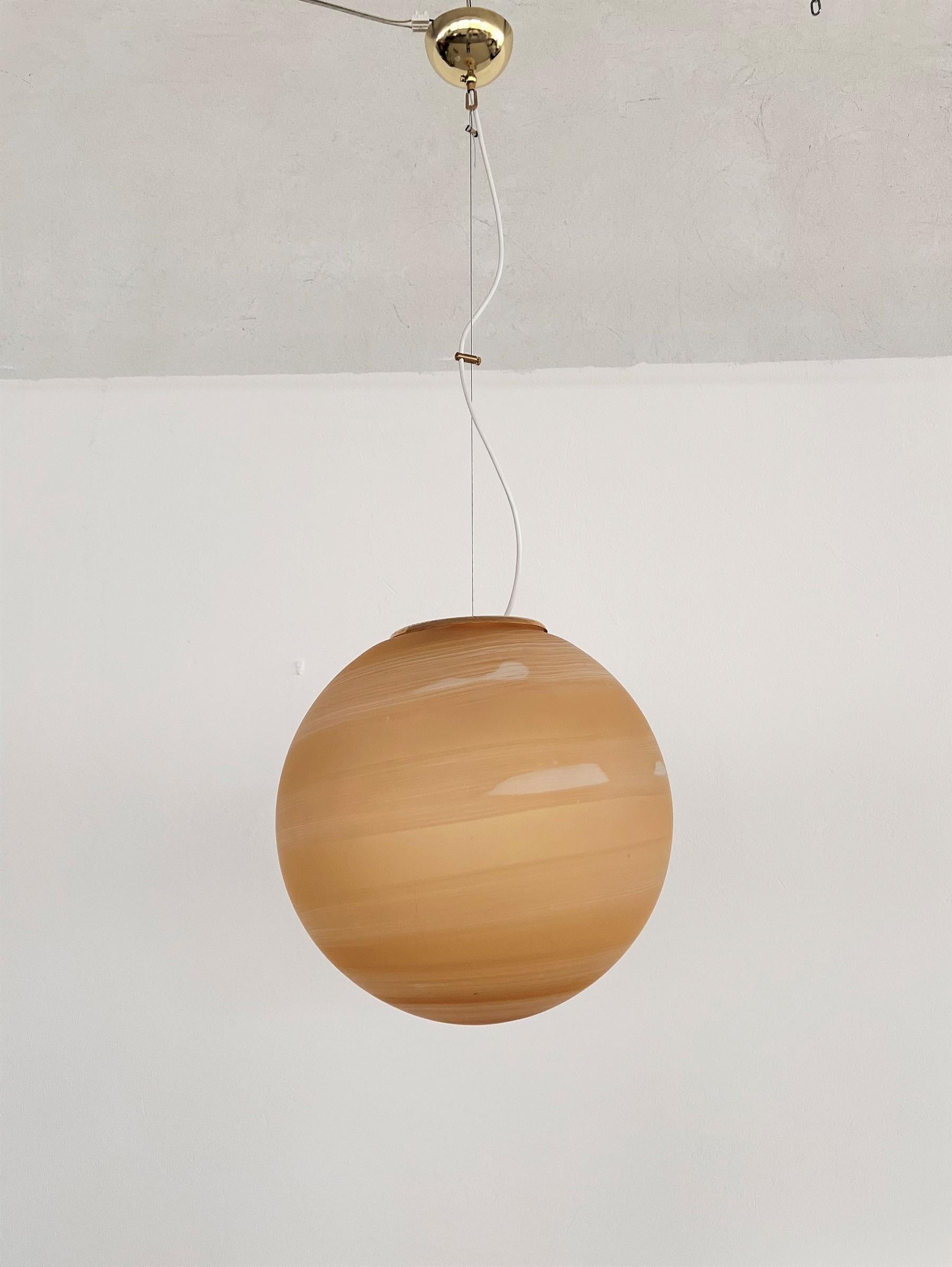 Beautiful vintage Murano glass globe pendant lamp with very heavy hand-crafted Murano glass and brass details.
The diameter of the glass globe is 15,7 in, and the actual height is 41,3in ( adjustable).
Made in Italy in the 1970s.
The lamps glass