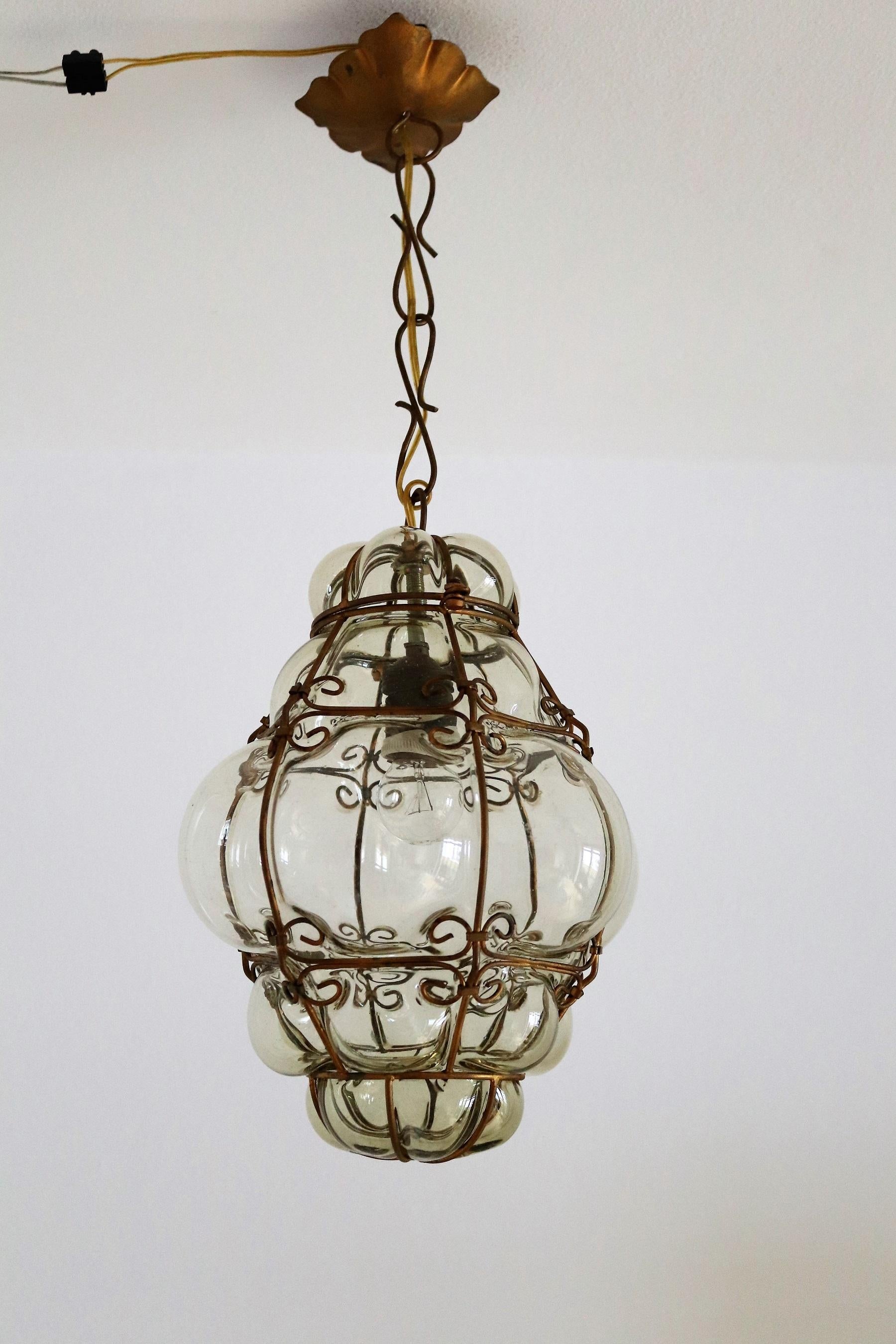 Gorgeous hand blown pendant light or lantern, Made in the 1950s in Italy, Murano.
The glass is blown inside the metal cage by skilled artisan.
Leaves beautiful shadows on wall and ceiling when illuminated !
The glass is in mint condition.
The