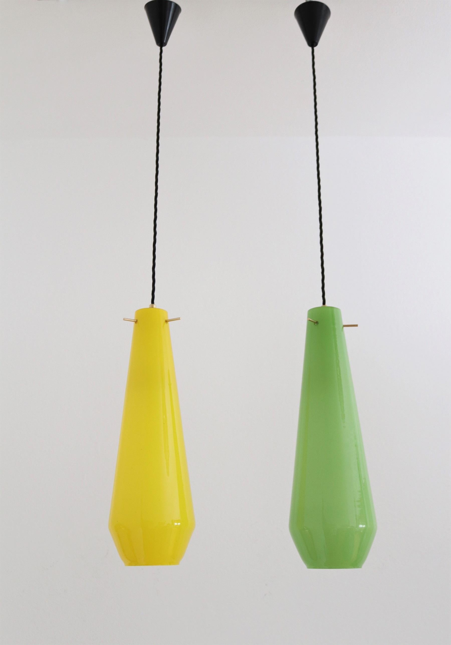 Beautiful pair of two glass pendant lights in different, shiny colors: green and yellow.
Made in Murano, Italy in the mid-century of the 1960s - 1970s.
Both lamps are in great shape and condition, and have minimal mouse bite chips around the holes,