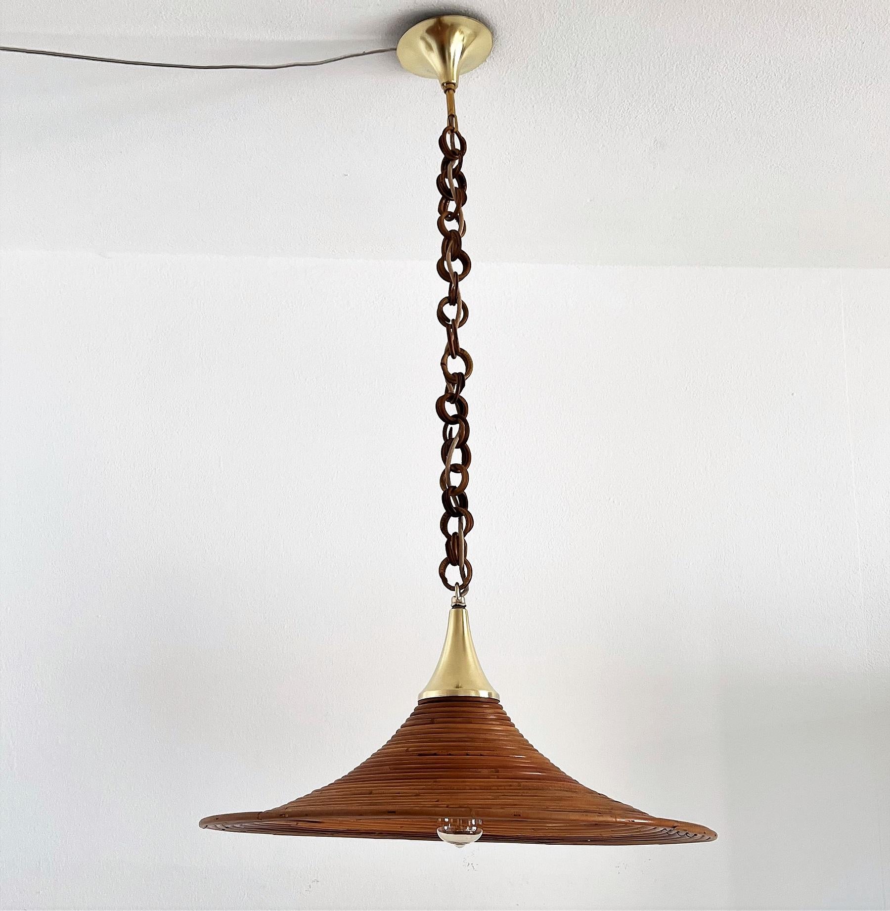 Gorgeous pendant lamp hand-crafted of curved bamboo with brass details and original wicker chain.
The pendant lamp is in very good original condition, the bamboo without defects but may of course show little signs of age as different color nuances