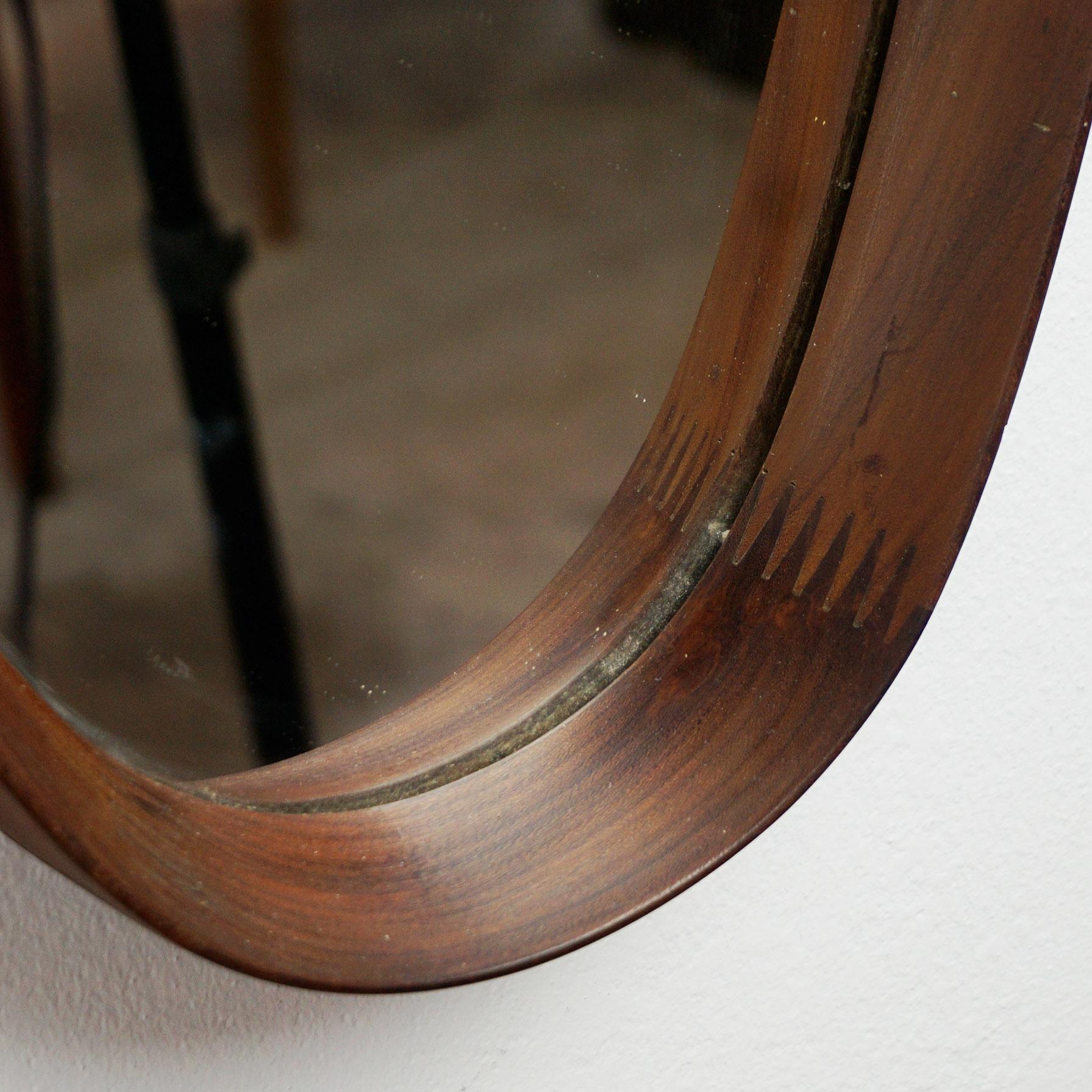 Charming Italian midcentury wooden oval mirror with cord, excellent craftsmanship.
