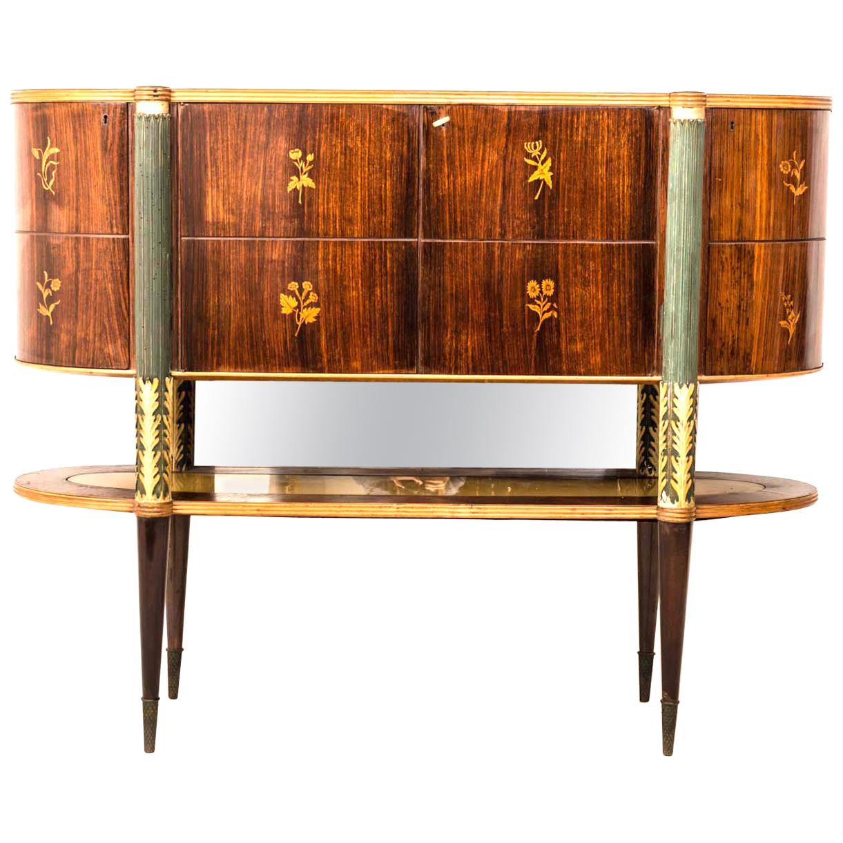 Unusual and rare sideboard designed by Pier Luigi Colli. Features finely carved and painted legs decorated with acanthus leaves.
Decorated front doors with nature motifs with the use of precious woods centred by a bar cabinet with