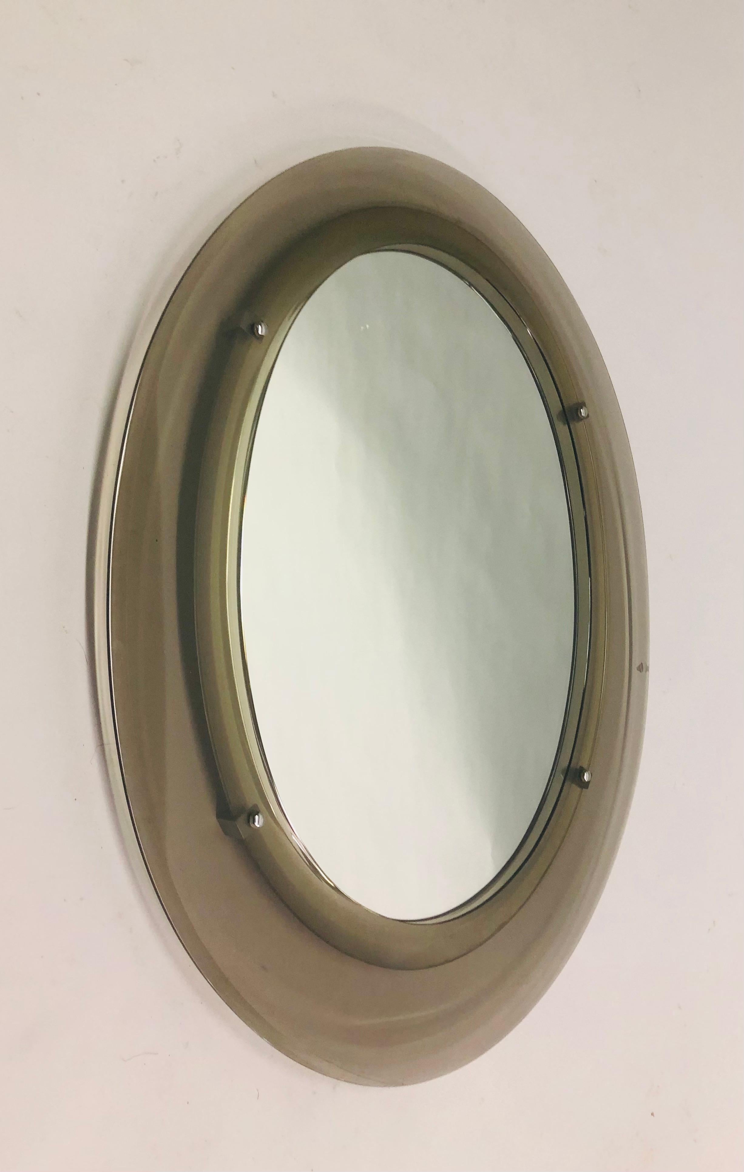 A large, rare, luminescent Italian Mid-Century Modern mirror in an Oval Form, with a translucent light grey Murano glass frame, attributed to Max Ingrand for Fontana Arte circa 1960 The piece is elegant and understated and the sublime ovoid form and