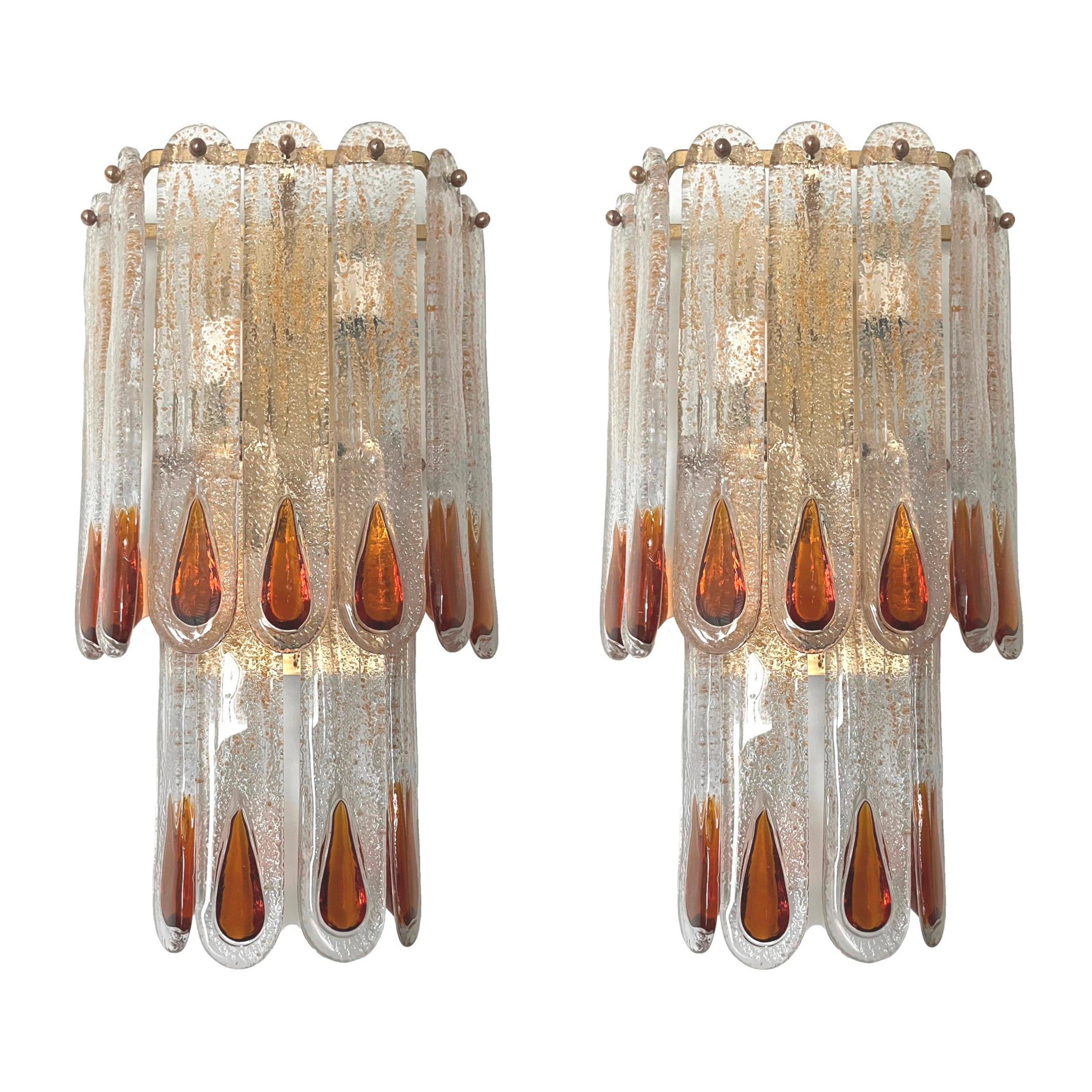 Stunning and beautiful Pair of Italian amber Murano glass wall sconces from 1970s.
These sconces were made during the 1970s in Italy for the Venice Company “Mazzega”.
Each wall sconce is composed by 11 units of Murano glasses (H 11.81 in. 30 cm x