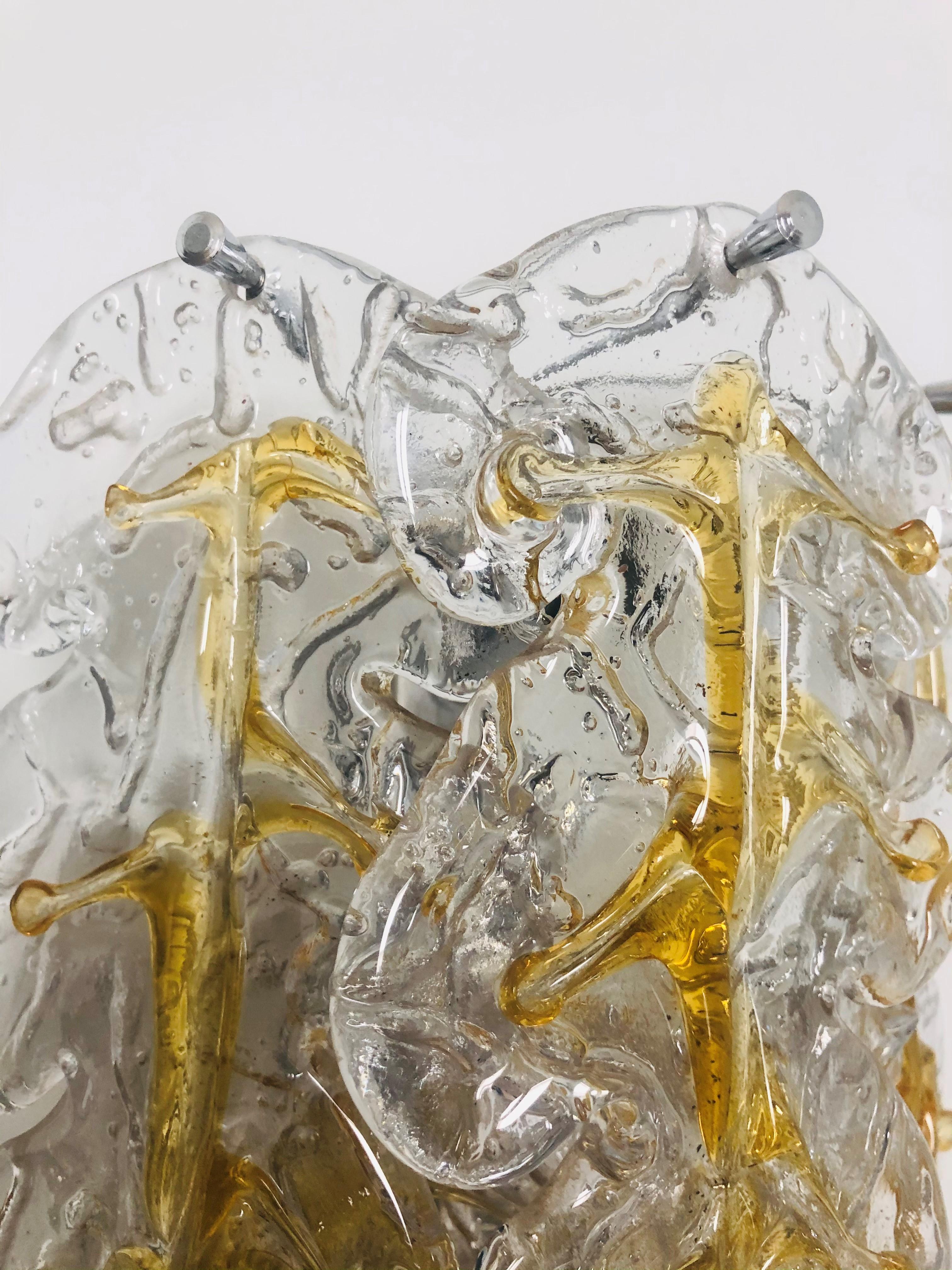 Marvelous, stunning and long pair of Italian clear yellow Murano glass wall sconces from 1970s. These fixtures were made during the 1970s in Italy for the Venice Company “Mazzega”.
Each wall sconce is composed by 6 units of Murano glasses and metal