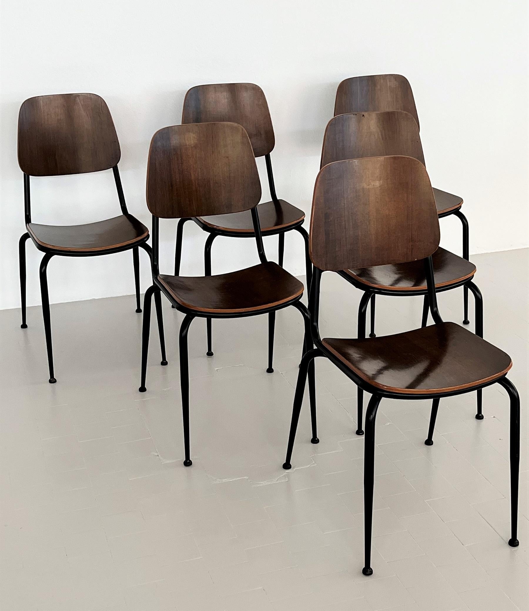 Gorgeous set of six chairs made by Velca Italy during the 1960s.
Each chair has a solid metal base, varnished originally in black color.
The seat and backrest are made of molded laminated nut-wood plywood.
The chairs are comfortable and can be