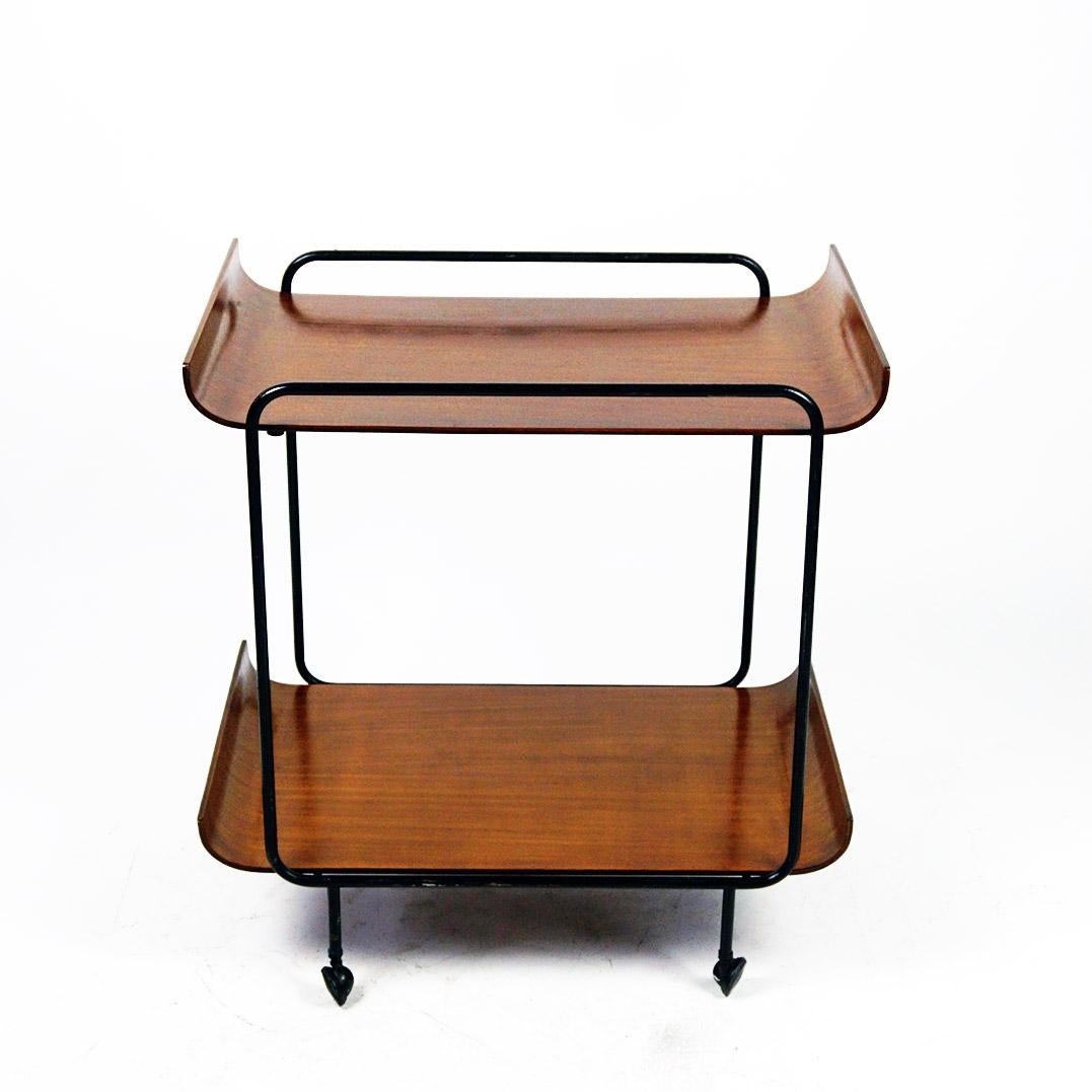 This Charming Italian Midcentury Bar Cart or Serving Trolley was produced by Creazioni Stilcasa and designed by Franco Campo and Carlo Graffi in Italy 1950s.
It features two removable shelves and a Black painted metal structure and rubber and metal