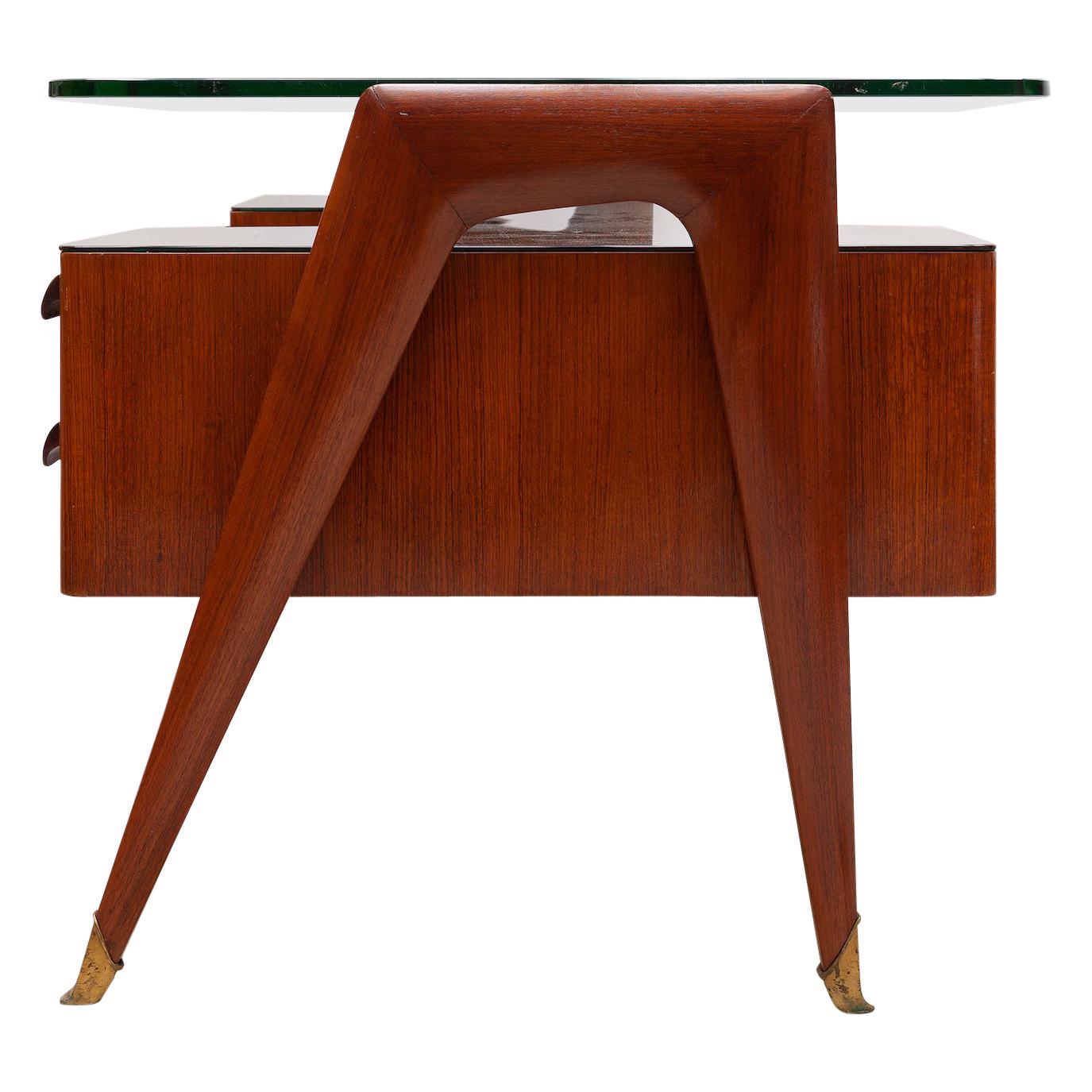 Vintage Mid-Century Modern Italian desk in presidential style designed by Vittorio Dassi, 1950s. Beautiful walnut construction with intricate inlay. Four dovetail drawers with key. Brass capped feet. Black glass under layer with a floating clear