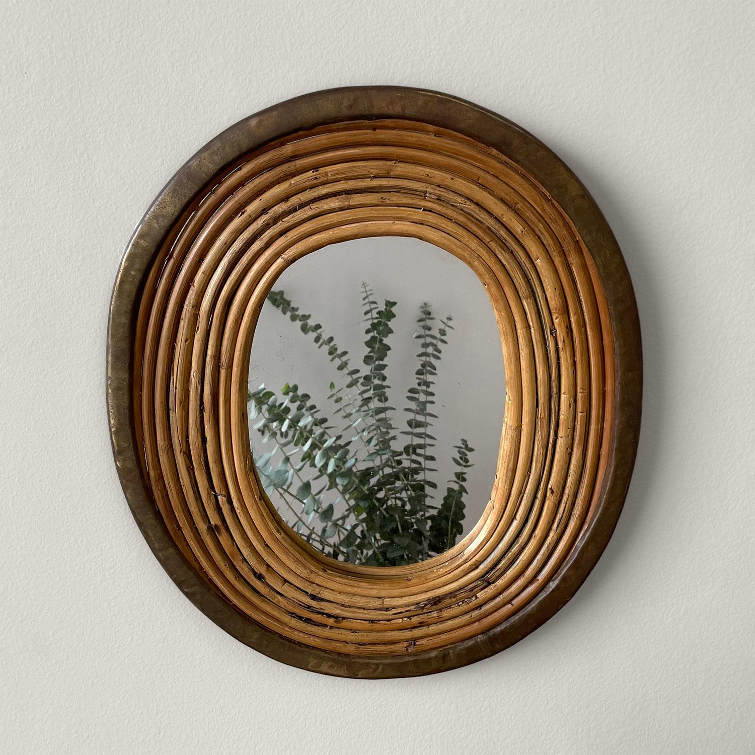 Italian rattan & brass mirror
Italy, circa 1970’s
Coiled rattan frame with aged brass trim
Original oval mirror has light surface markings
Patina from age and use
Perfectly imperfect

OAD: 14.5” H x 12.625” W x .625” D
Mirror: 8.5” H x 6.375”
