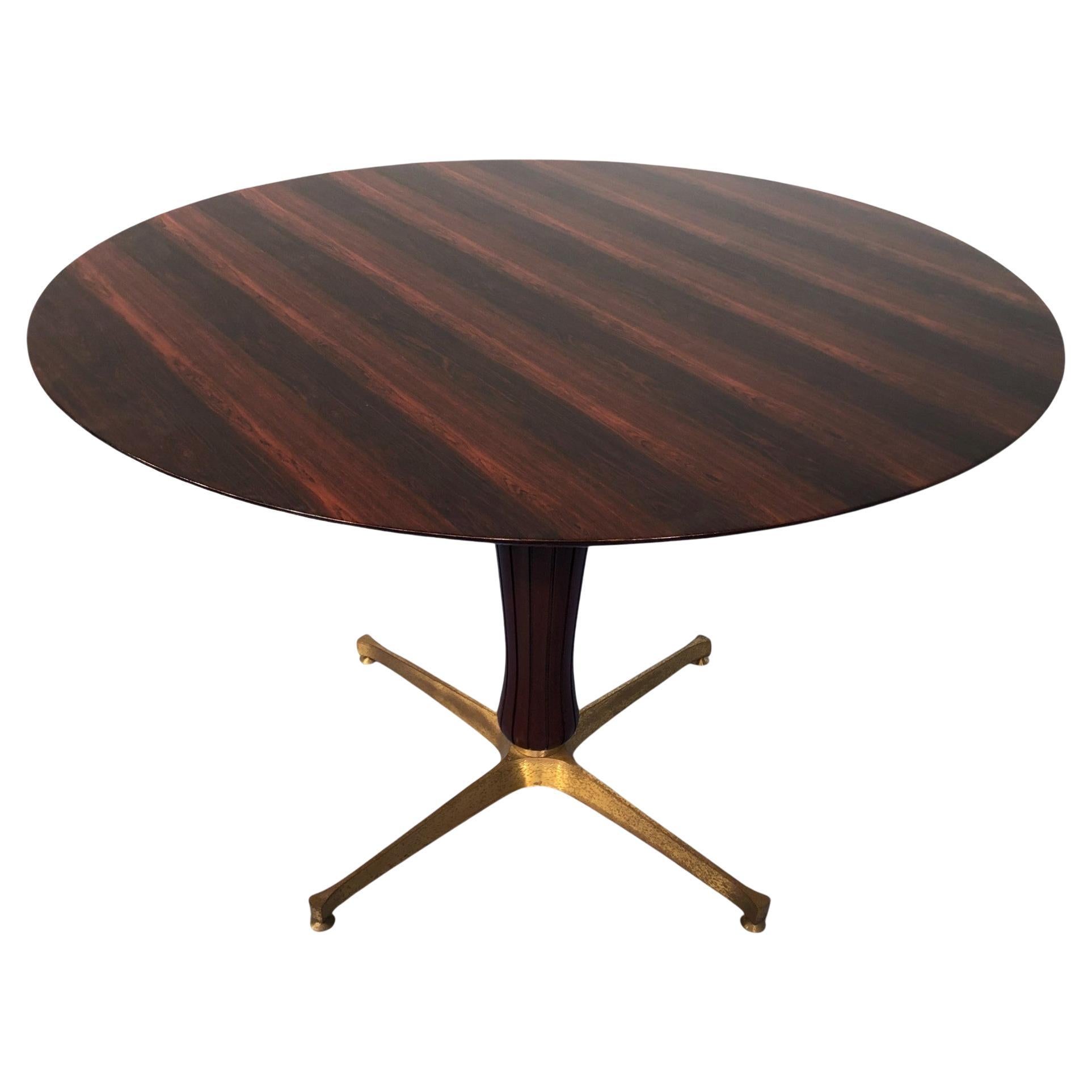 This Italian midcentury teak table attributed to Paolo Buffa 1950, is an example of pure Italian design on the period.
The round top is completely in rosewood with spectacular colour and texture. The central mahogany leg has grooves, typical of