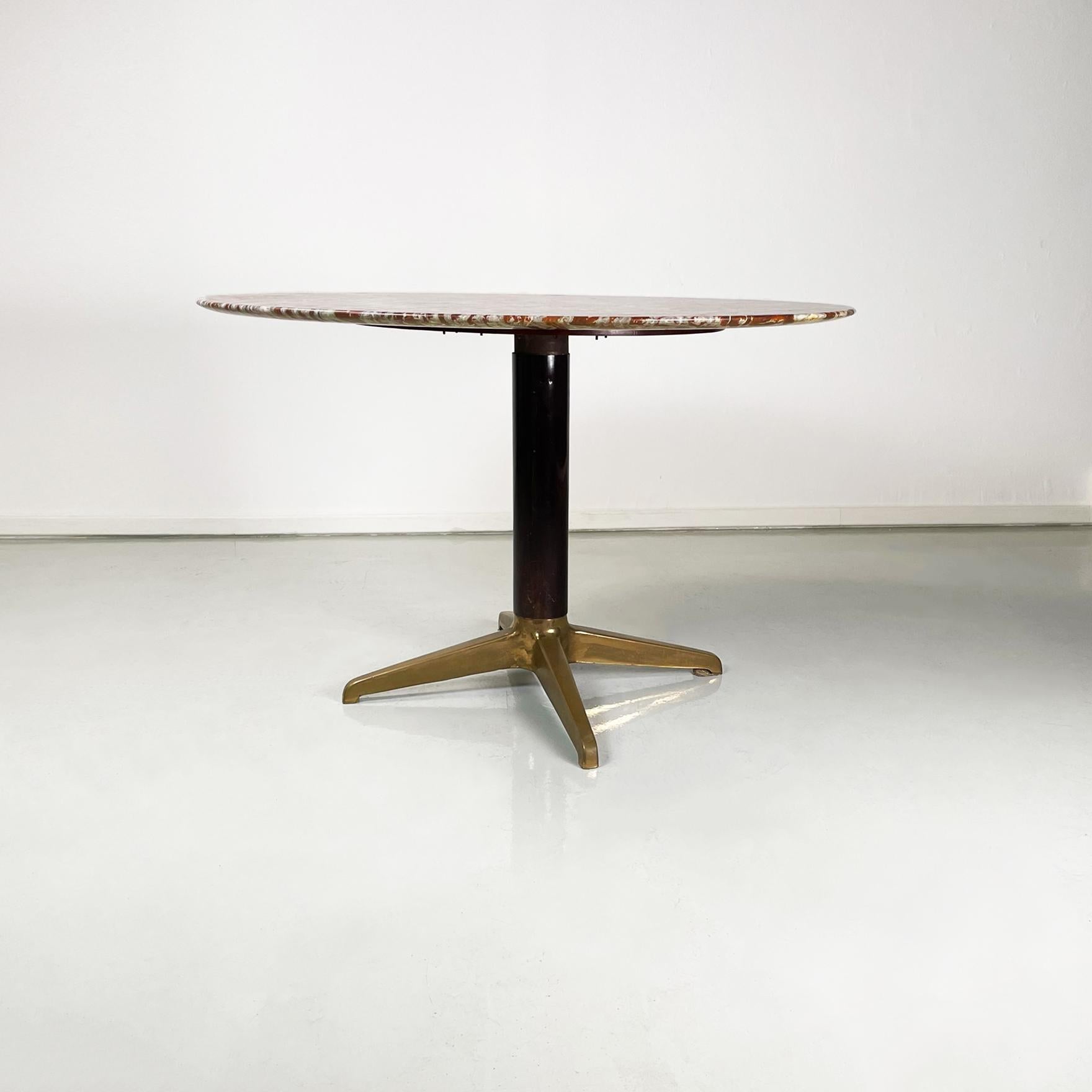 Italian mid-century Round dining table in red marble, black wood and brass, 1950s
Fantastic dining table with round thin top in red and white marble. The central leg is in black painted wood and ends with 4 brass spokes.
1950s
Very good