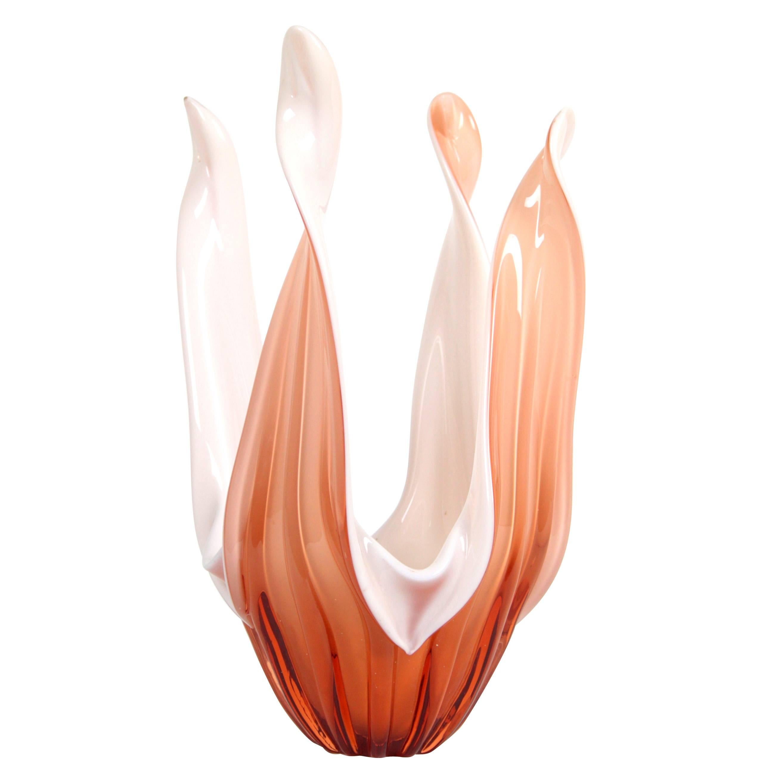 An sculptural Mid-Century Modern Murano glass vase or centerpiece with beautiful curly shapes and amazing color. Italy, 1960s
It has made with mouth blown technique in opaline glass and clear peach color glass.
Measures: 24 cm W x 24 cm D x 38 cm