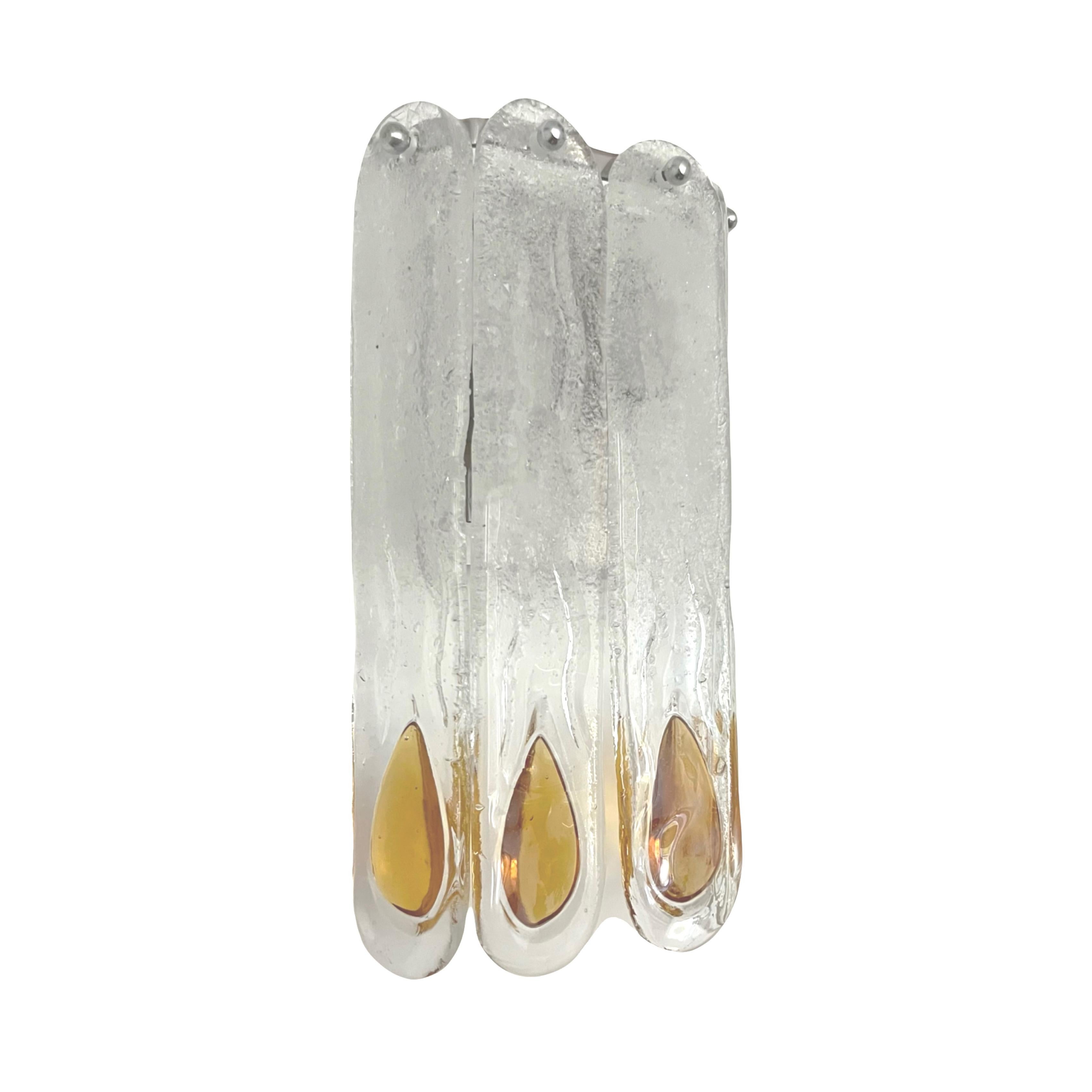 Stunning and beauty Set of Four Italian Amber Clear Murano glass Wall Sconces. These fixtures were designed and manufactured during the 1970s in Italy by Mazzega.
Mazzega lie in the noble Venetian glassworking tradition; the firm was founded Angelo