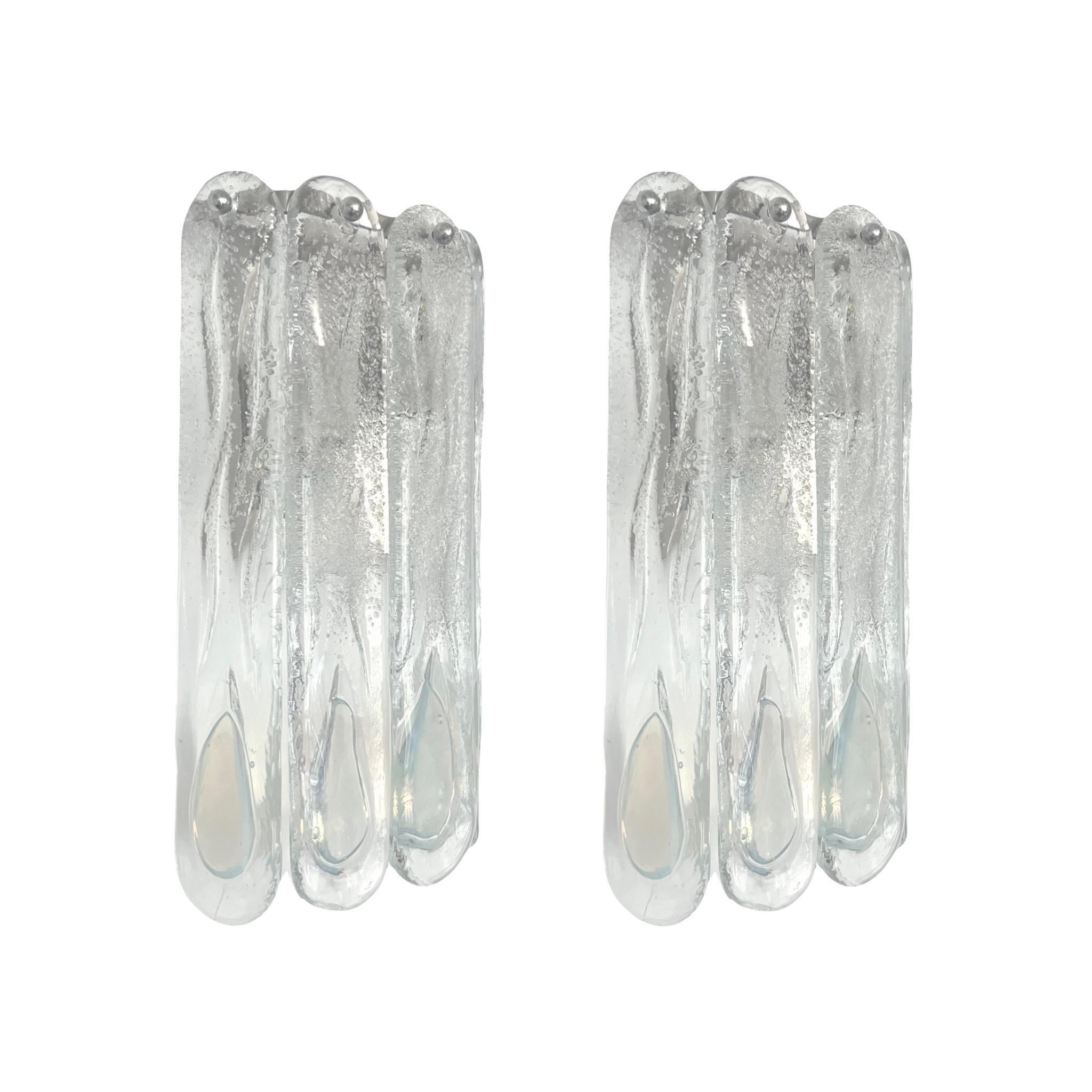 Stunning and beauty Set of Three Italian Iridescente White Clear Murano glass Wall Sconces. These fixtures were designed and manufactured during the 1970s in Italy by Mazzega.
Mazzega lie in the noble Venetian glassworking tradition; the firm was