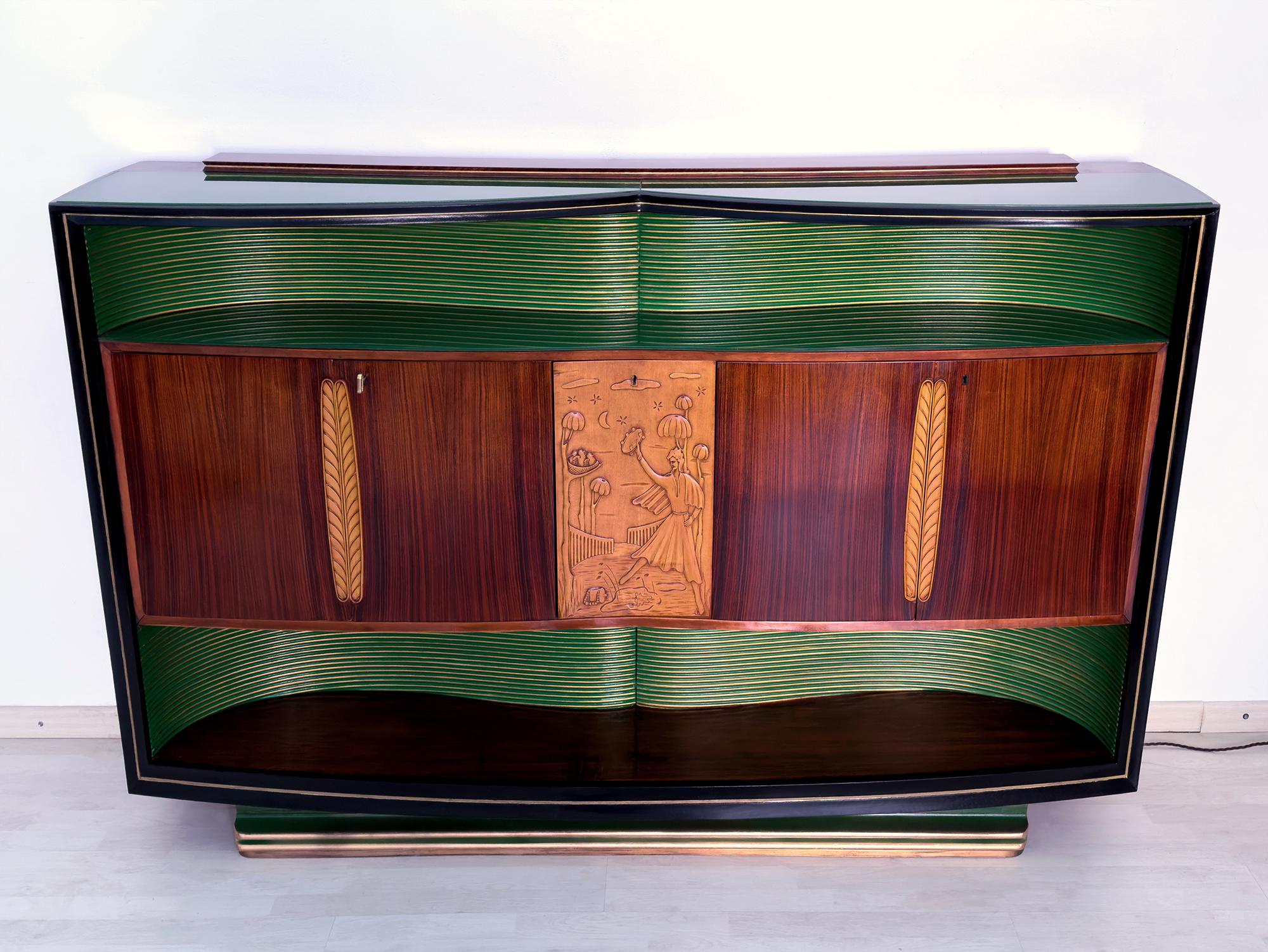 Stunning Sideboard and/or Bar cabinet designed by Vittorio Dassi in the 1950s.

It’s finished with long shaped colored green glasses that give it a particularly brightness, one placed on the top plane and the other one inside the hollow, internally