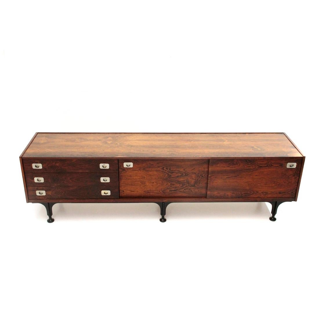 Italian manufactured sideboard produced in the 1960s.
Structure in veneered wood.
Three drawers and storage compartment with sliding doors.
Chromed brass handles.
Legs in black painted wood.
Good general condition, some marks, halos and lack of