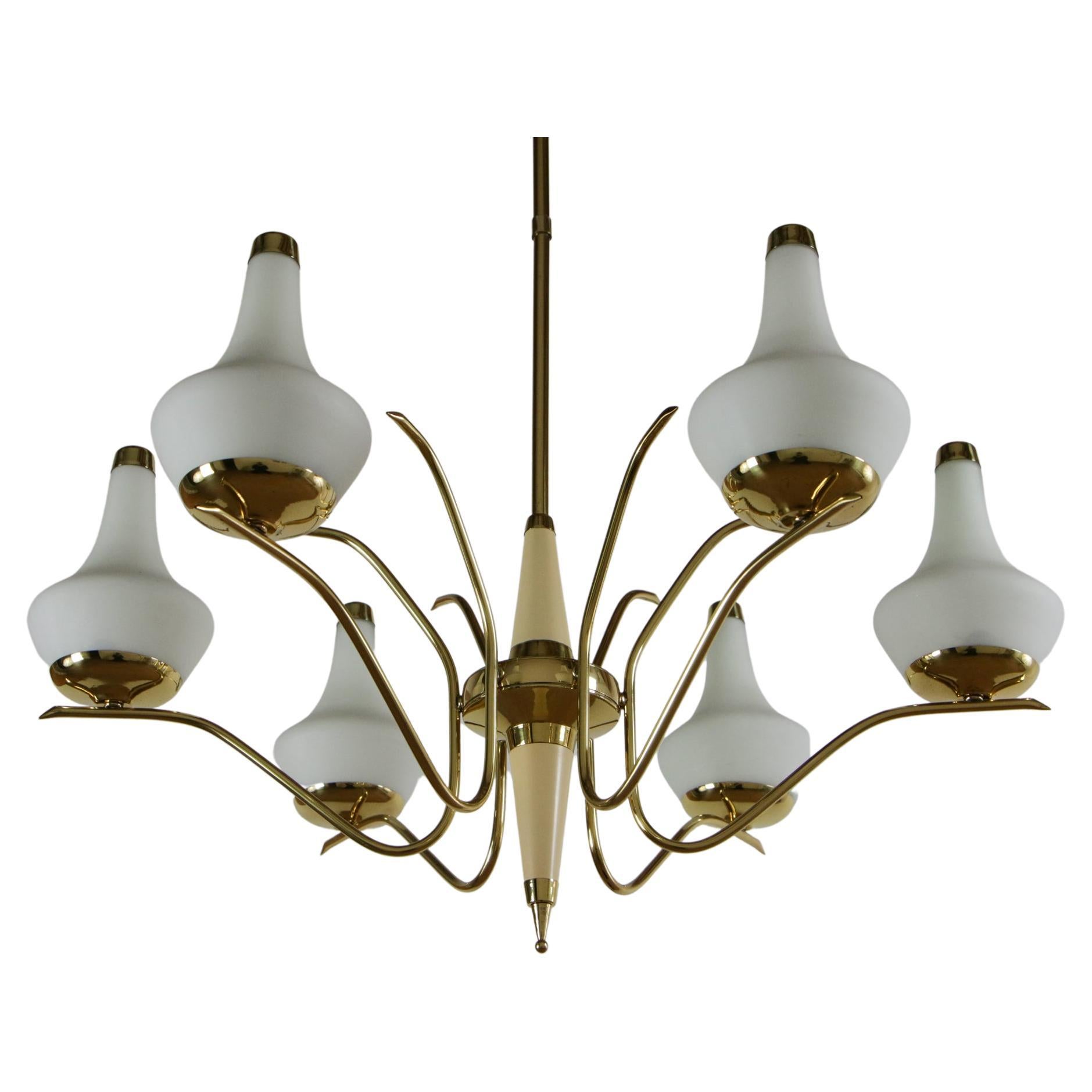 This beautiful Italian gold and ivory color chandelier from the 1950s is attributed to Stilnovo and features polished brass, ivory lacquered aluminum, opaline-coated glass, and six E14 light bulbs. 

The design of the chandelier is truly elegant,