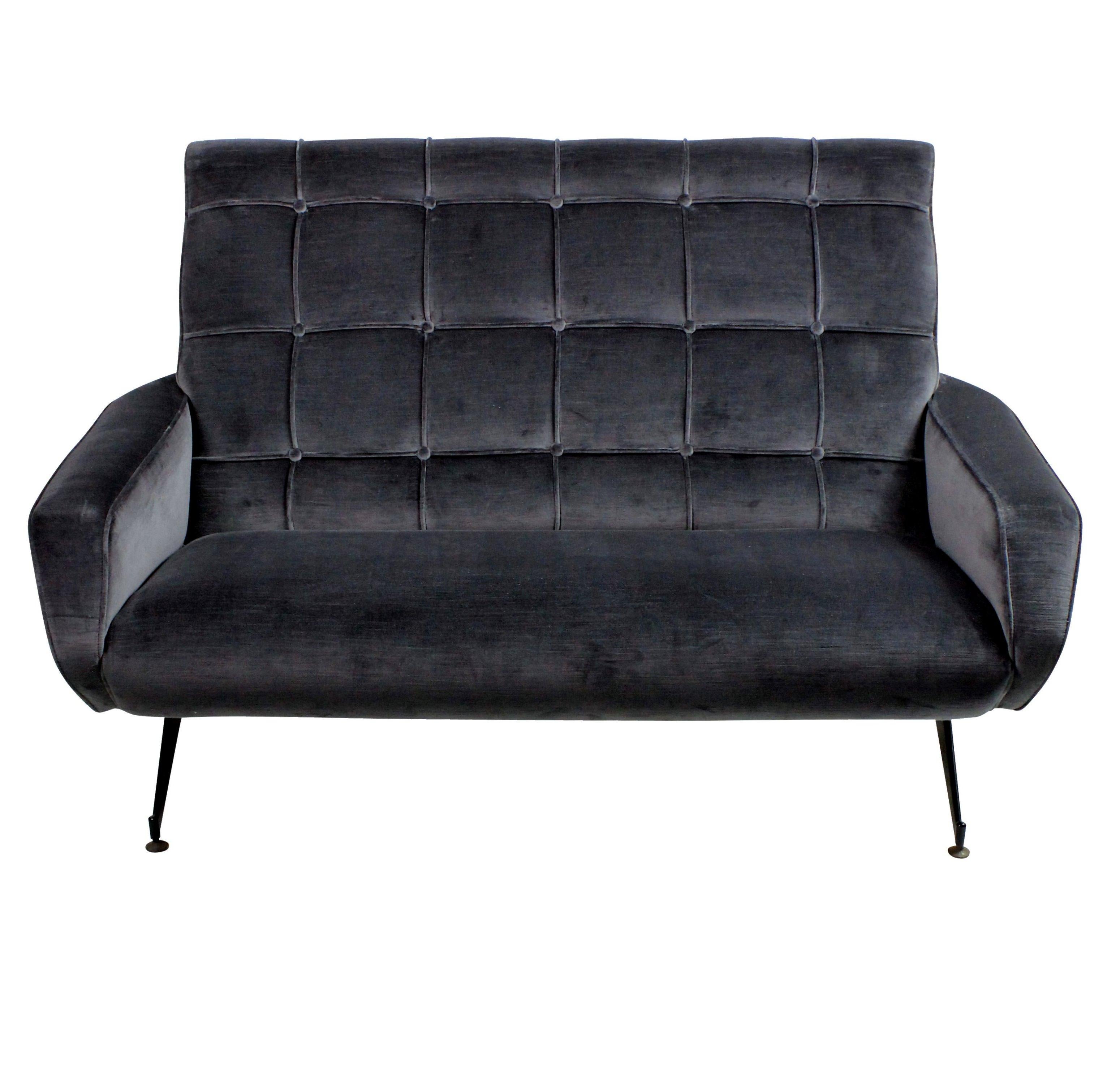 An Italian two-seat settee in the style of Arflex, with detailed buttoned back and angular shape, supported on black enameled legs. Newly upholstered in ribbed blue or grey velvet.