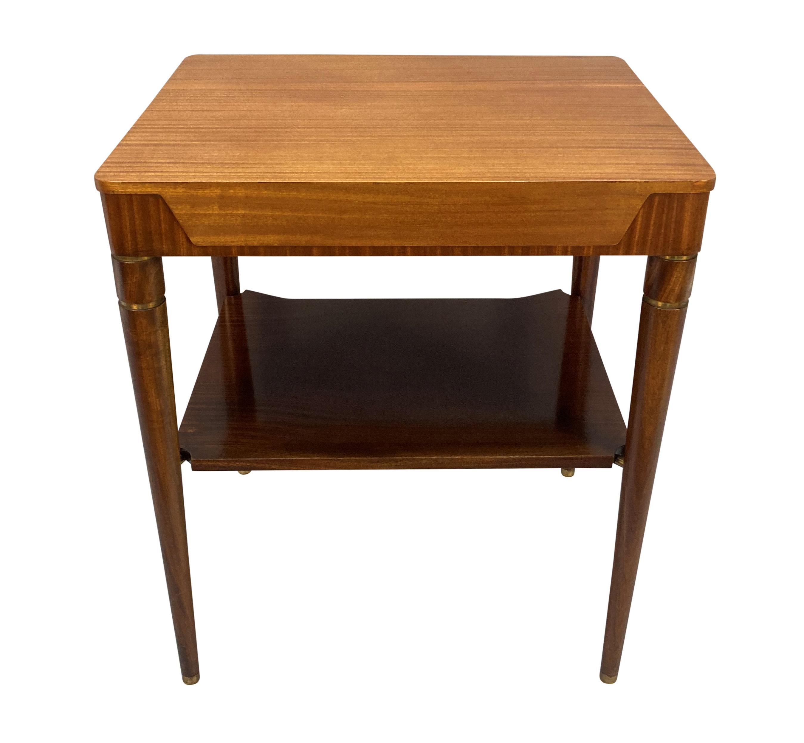 An Italian Mid-Century sofa table, with brass detailing and a lower shelf.