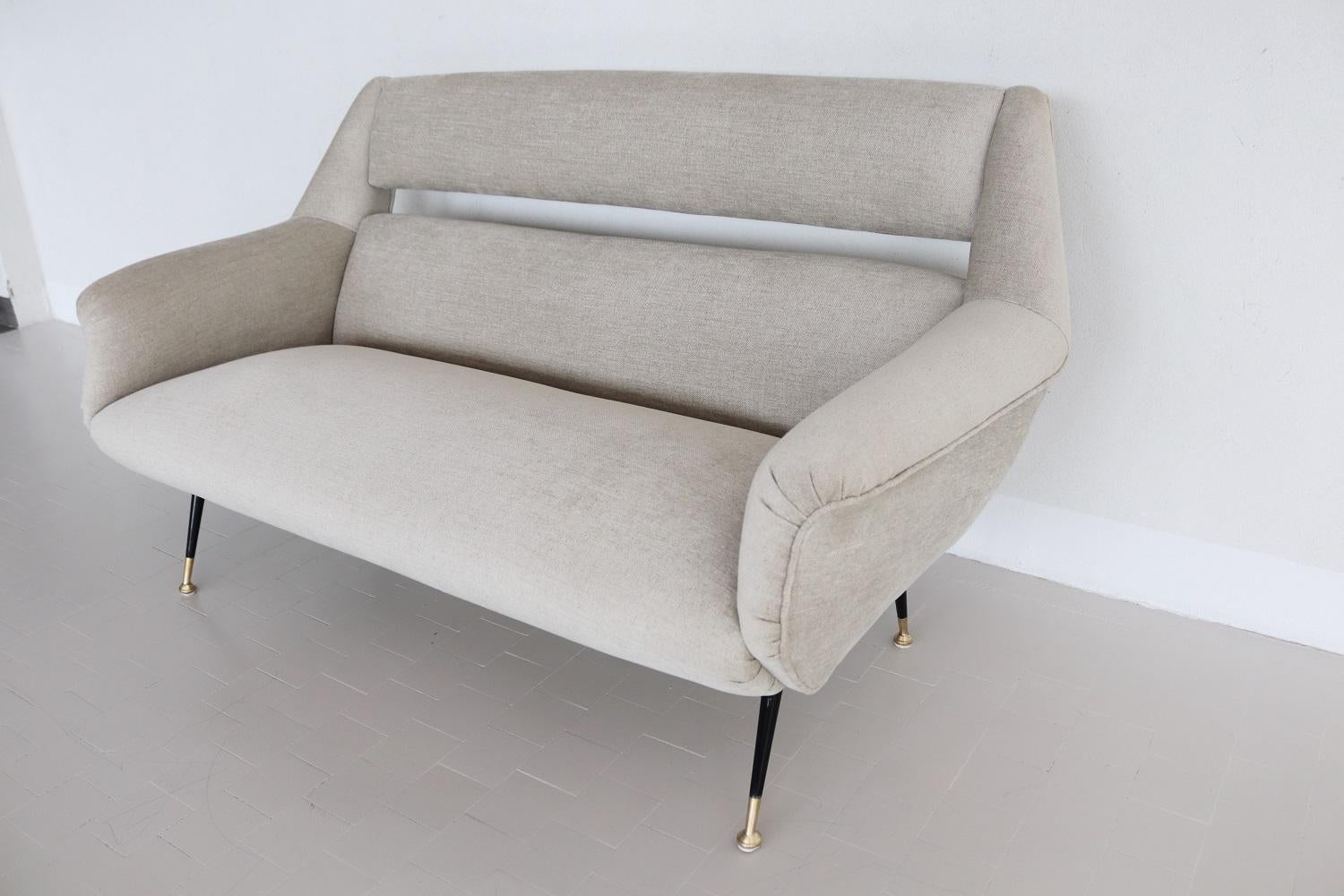 Magnificent midcentury sofa manufactured in the 1950s in Italy.
The design of the sofa is very much in the style of Carlo de Carli.
The sofa have been completely re-upholstered with soft chenille fabric in sand-white color and internally