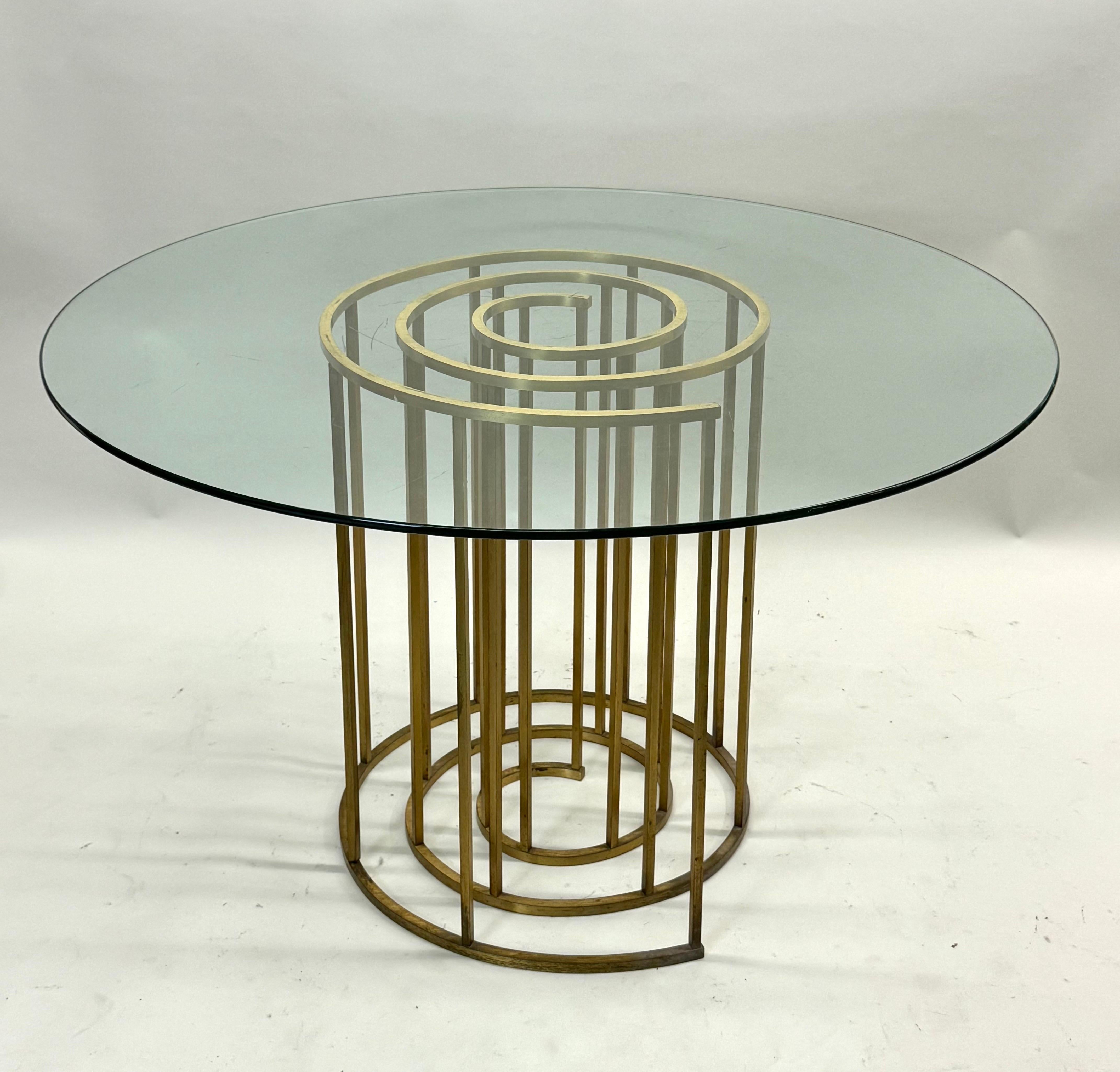 An Elegant Italian Mid-Century Modern Spiral Form Brass Dining / CenterTable Base Attributed to Luciano Frigerio, Italy, circa 1970. The table base is aesthetically dramatic and provides a poetic and rhythmic focus to offset more traditional
