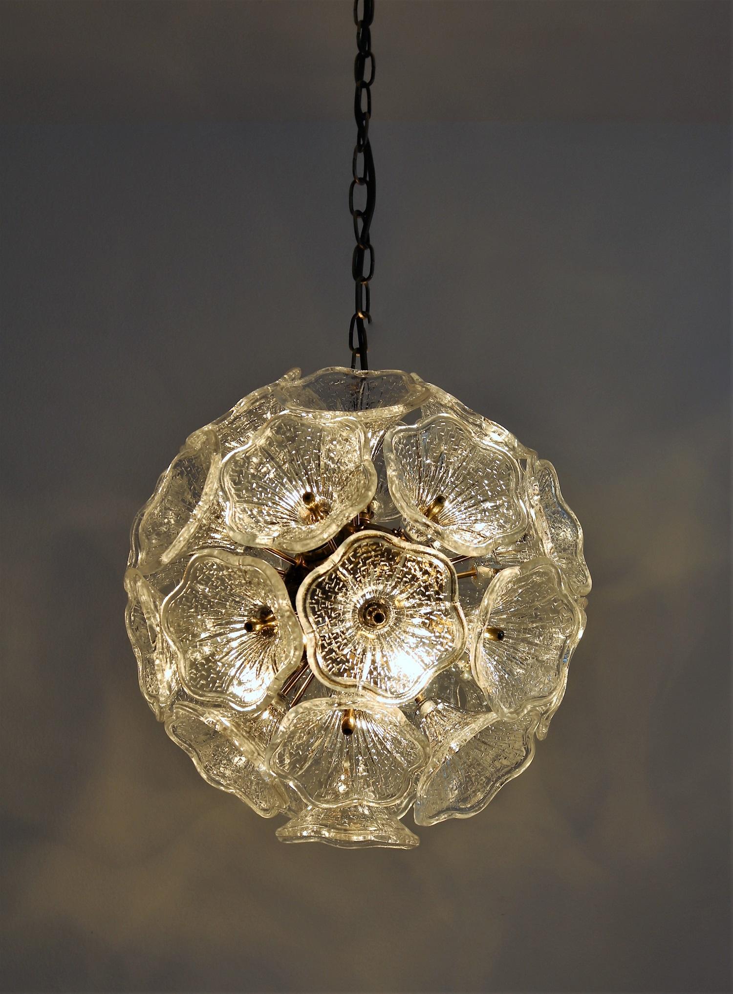 Gorgeous spherical Sputnik chandelier with 31 big glass flowers of high quality which are mounted with custom brass screws on dedicated brass globe. Inside the brass globe are the bulb holders for small candelabra bulbs.
The chandelier is original
