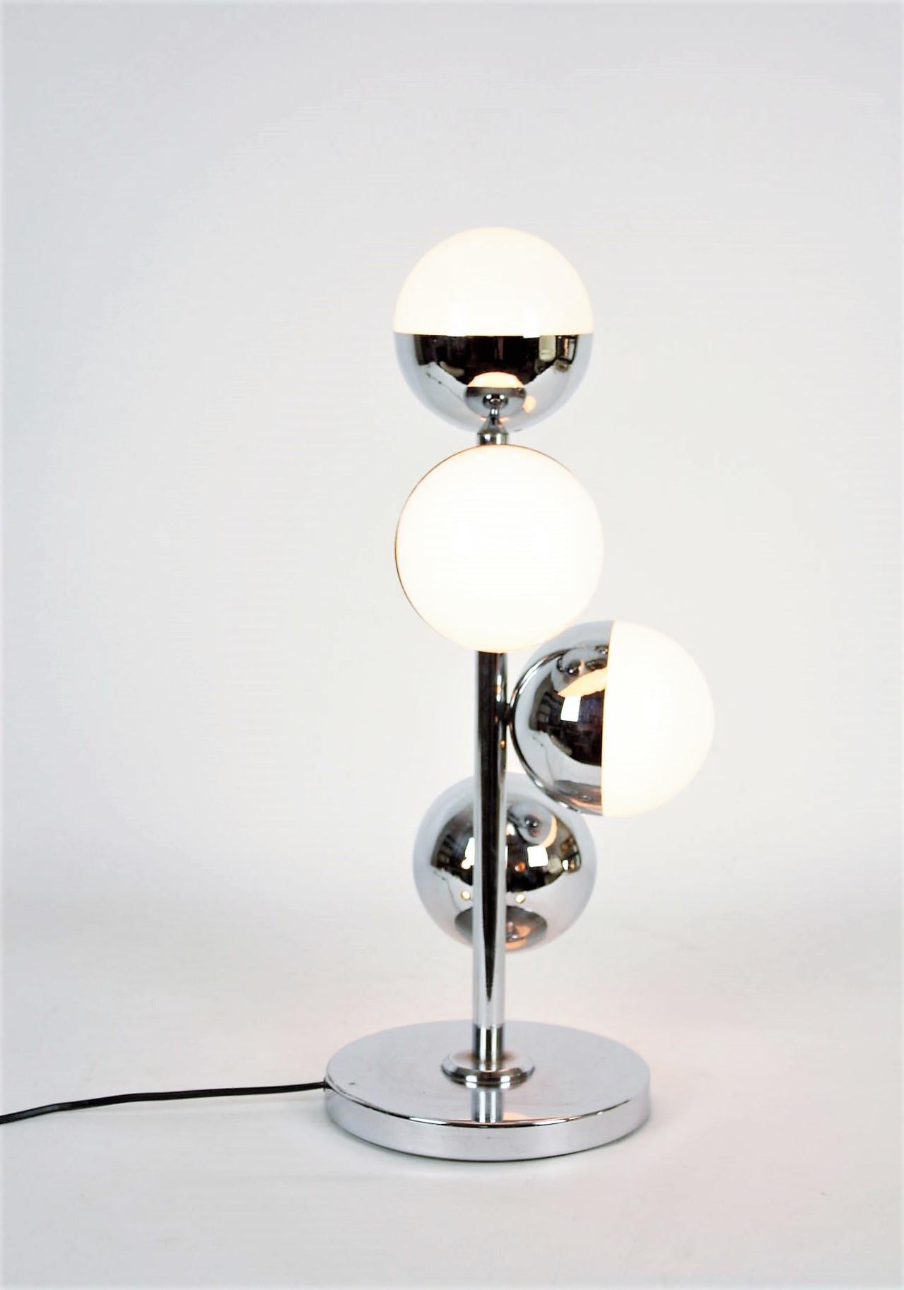 A chromed steel and opaline glass table lamp in the style of Stilnovo, Italy, 1960s.
It has a central chromed steel column holding 4 glass globe light in different heights.
Beautifully designed in the manner of Stilnovo.
Measures: 55 cm height x