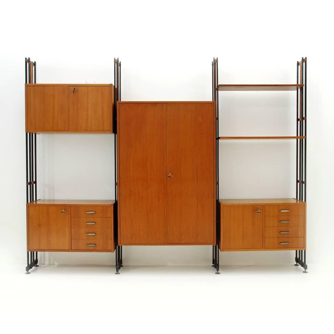 Italian library produced in the 1950s.
Uprights in black painted metal with wooden details and adjustable brass feet.
Containers and shelves in veneered teak wood.
Handles and keys, made of brass.
Structure in good condition, some signs due to