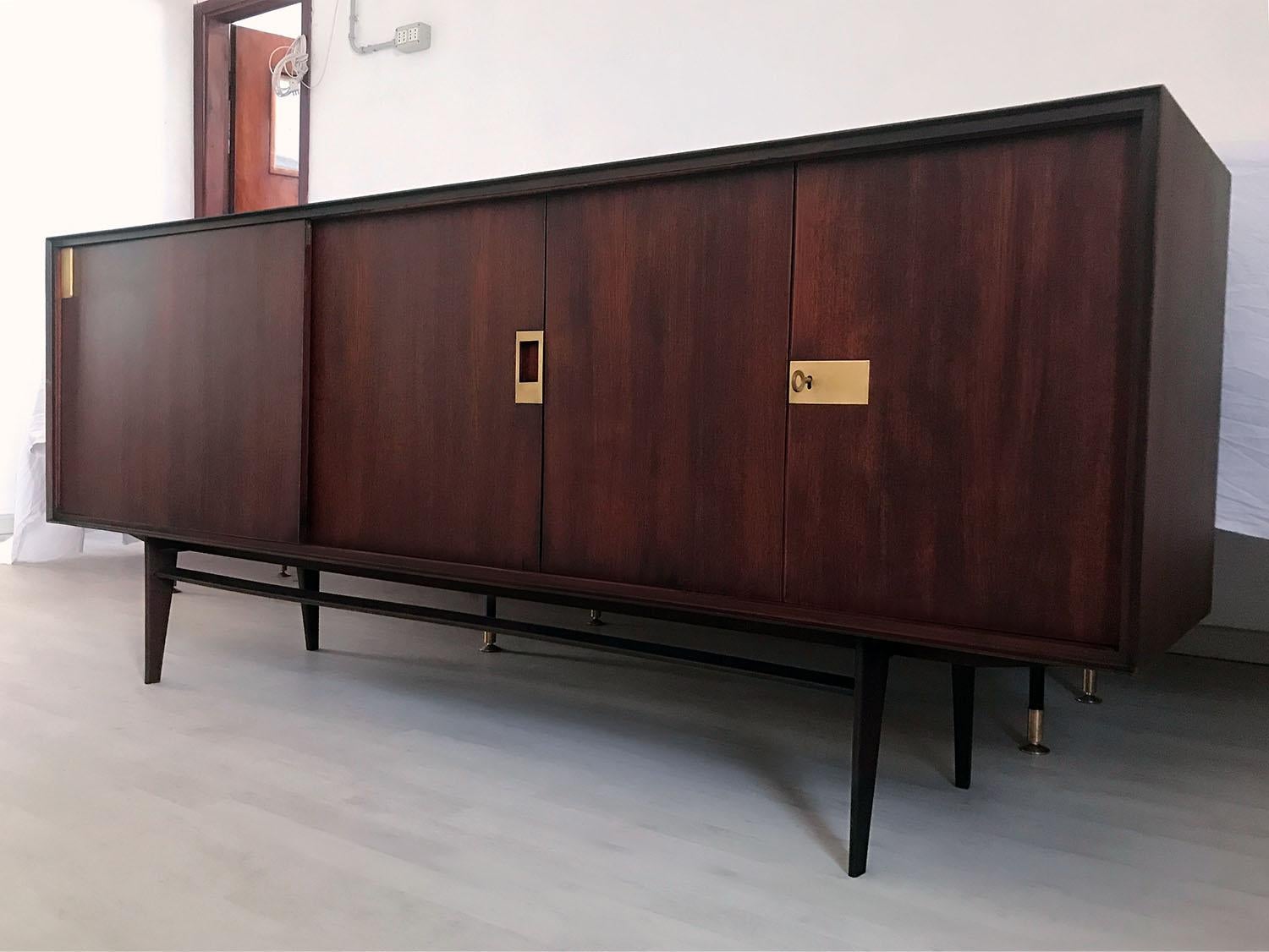 This sideboard has been crafted with a gorgeous material like as teakwood, and it’s finished with brass details.
It’s offers plenty of room for storage, the internal cabinets are equipped with shelves and on the left side a sliding door hide
