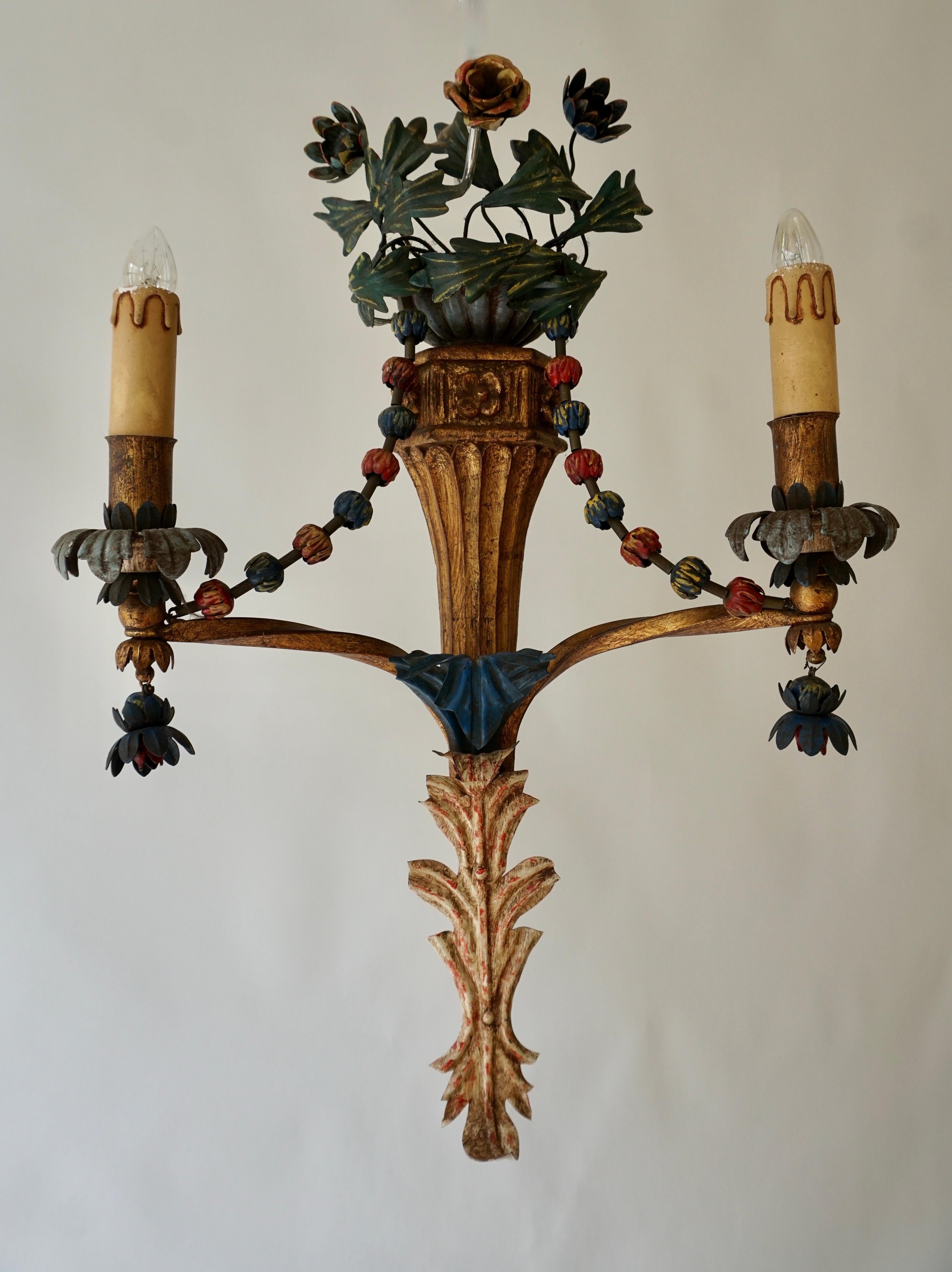 Four beautiful Italian tole wall sconces with colorful hand-painted flowers from the past century. 
Each wall light is wired for two small light bulbs with max. 60W. 
Very good vintage and working condition.