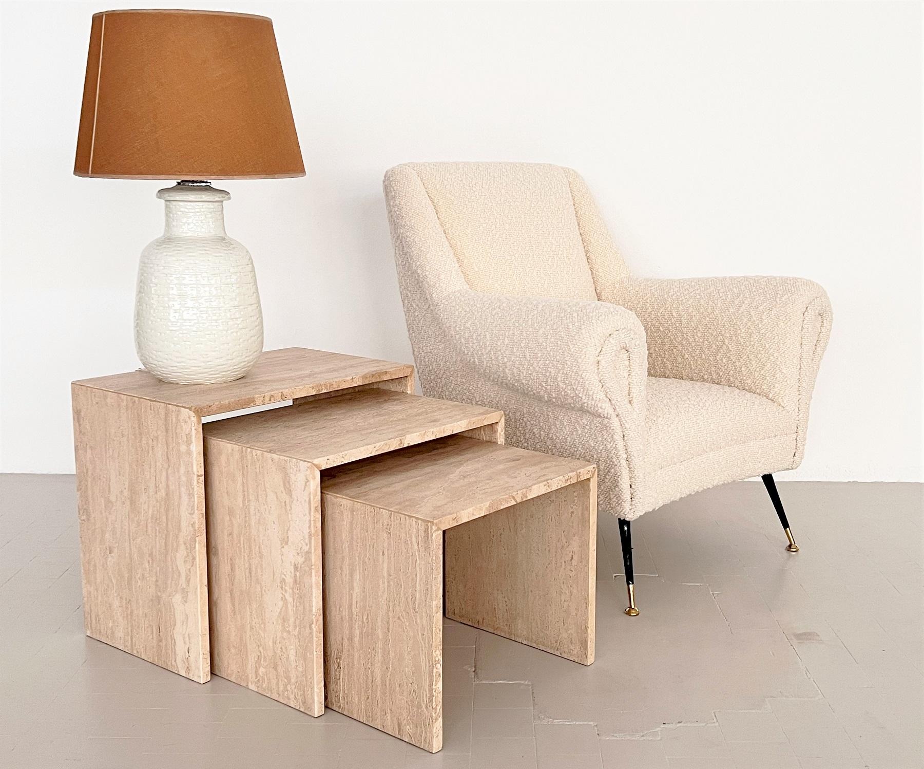 Beautiful set of three elegant nesting tables of three different sizes in order to be put one below the other.
Hand-Crafted in Italy in the 1970s of full Travertine of very elegant minimal appearance.
The Travertine has a beautiful stone pattern and