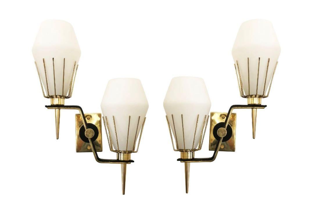 Italian midcentury wall lights attributed to Arredoluce. Frosted glass shades and brass frames with black lacquered details. Two candelabra sockets per sconce. Pair available. 

Condition: Excellent vintage condition, minor wear and oxidation