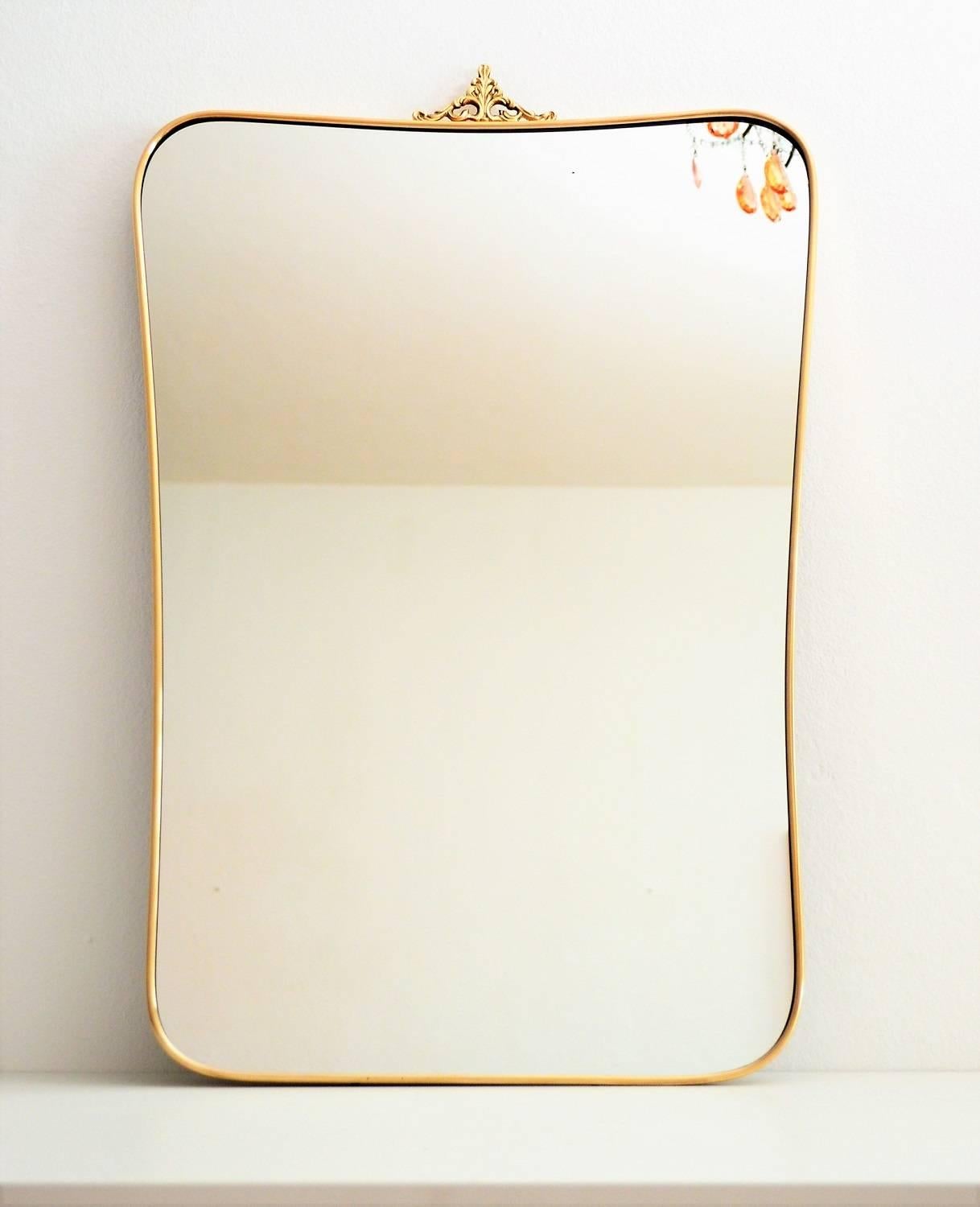 Beautiful crystal glass wall mirror with brass frame, typical for the Italian Mid-Century Modern age.
Made in Italy, circa 1950s.
The small golden metal decoration on the top of the mirror can be removed ( hold from 2 screws) if desired. We left it