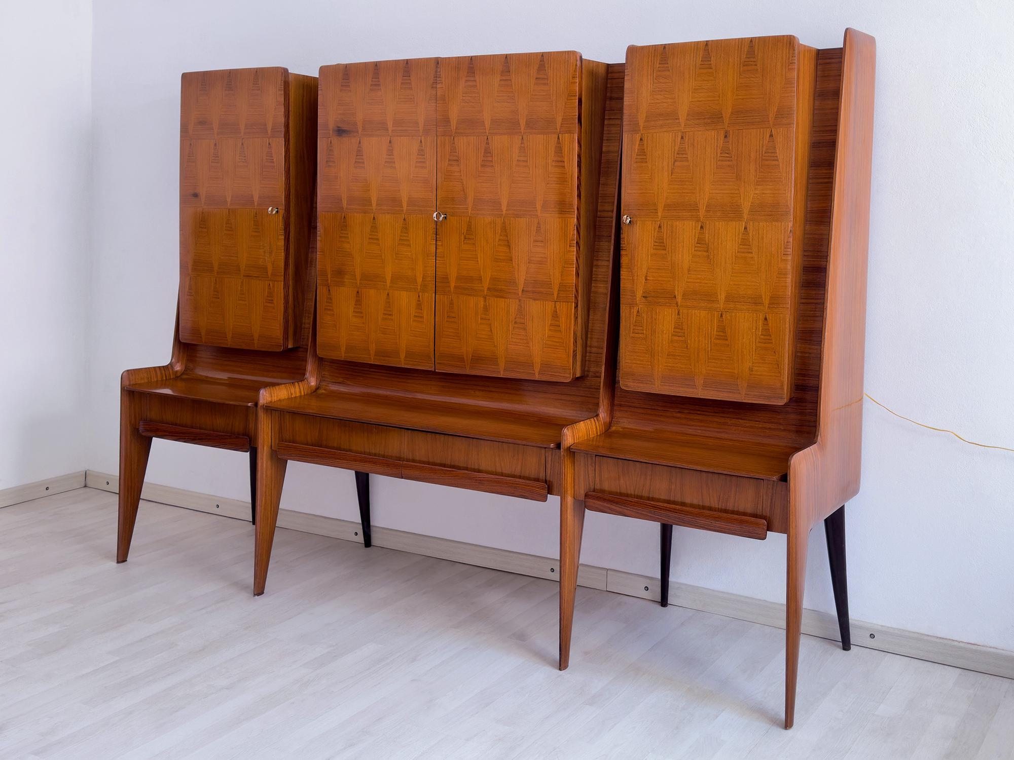 This wall Sideboard of 1950s is a stunning example of the mid-century Italian design, very rare and very well designed, certanly, by an important Italian designer of the period as could be for example Ico Parisi.
It bears the trademark Associazione