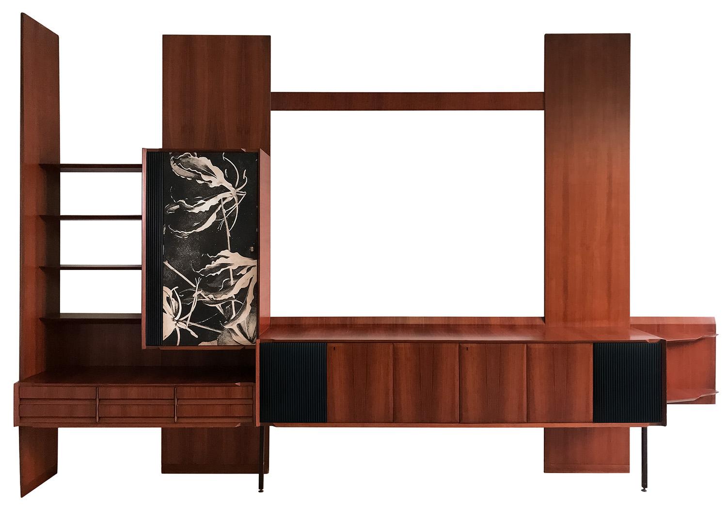 This is a Wall Unit well designed by Vittorio Dassi in the 1950s.
It offers plenty of storage space with several compartments, hinged doors, drawers and open shelves and it would be a great addition to any modern interior decor as home as well for