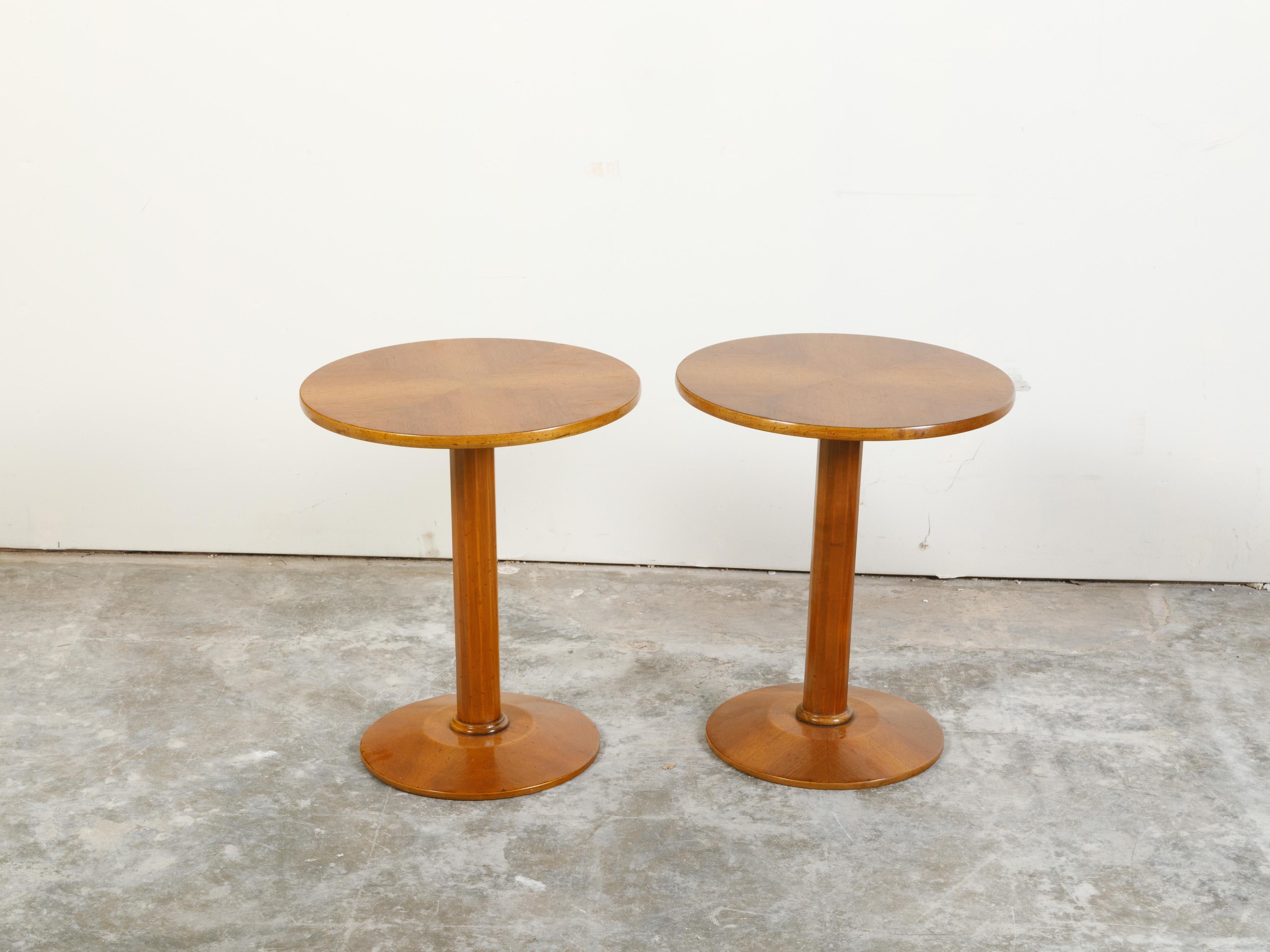 Two Italian vintage walnut drinks tables from the mid 20th century, with quarter-veneered tops and pedestal bases. They are priced and sold individually, $2,450 each. Created in Italy during the midcentury period, each table features a circular