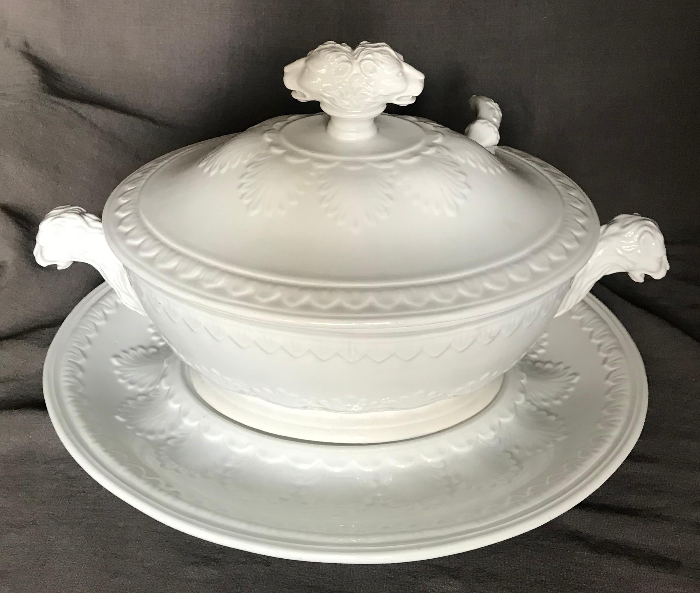 Italian midcentury white lion head tureen with ladle. Large white neoclassical style soup tureen of ovoid form with foliate decoration on lion head handled body, under-plate and lid with double lion-headed knopf; with original ladle and all in