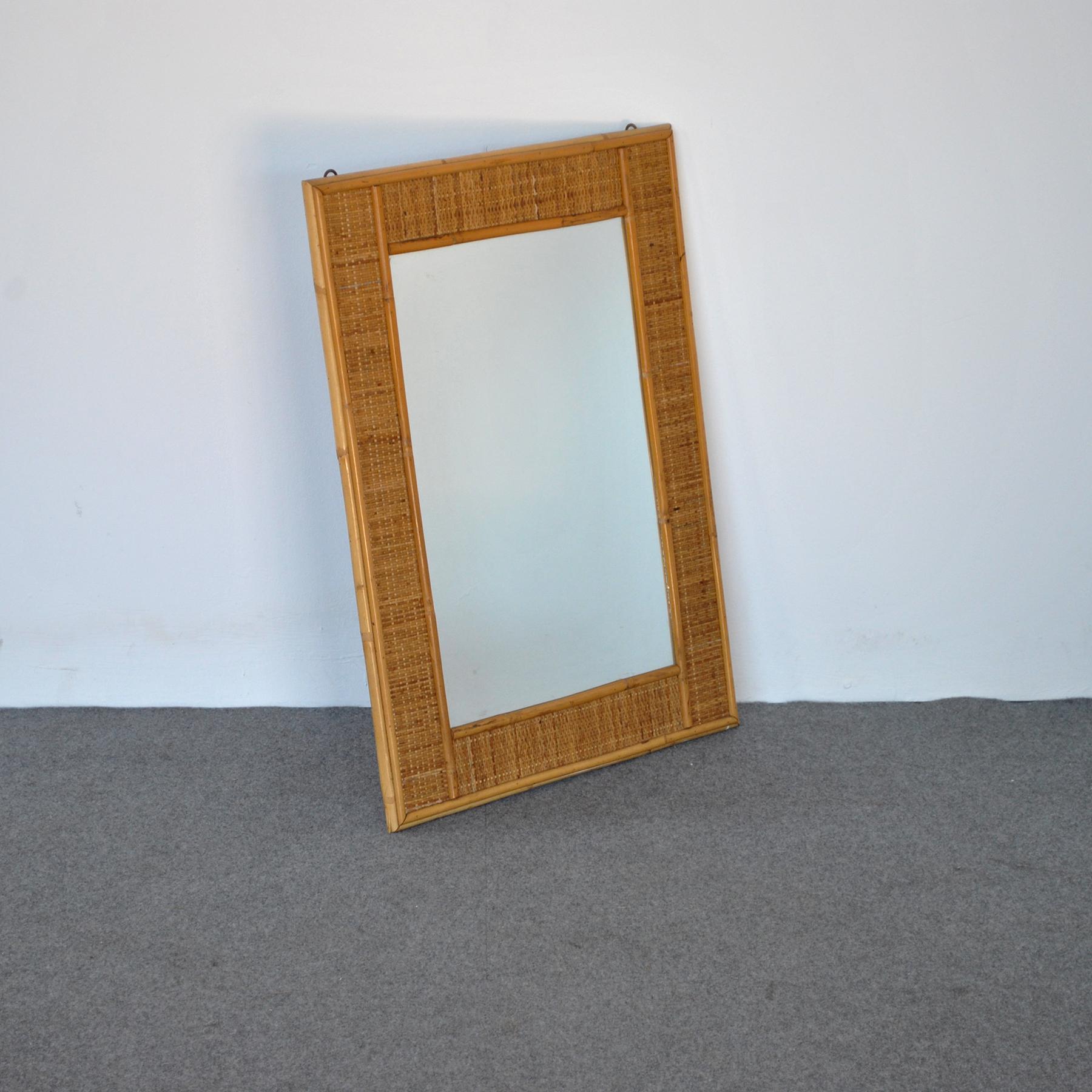 Mirror made in Italy from the late 1960s in wicker with bamboo profiles and frame.