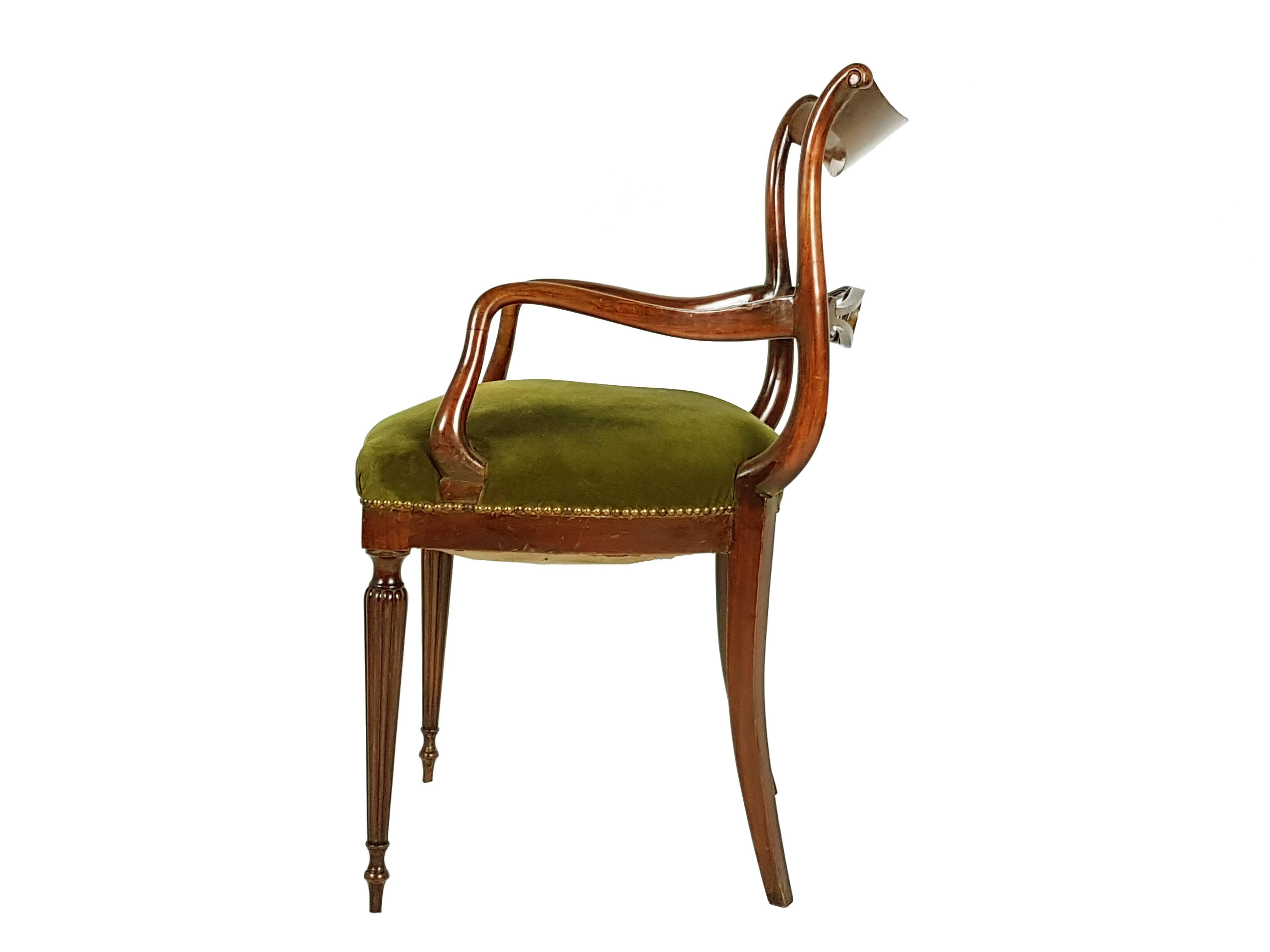 This beautiful armchair was produced in Italy, circa 1950s. It is made from a sculptural wooden structure with a green velvet upholstery. Its Classic and elegant style resembles contemporary products designed by Carlo Enrico Rava. The chair remains