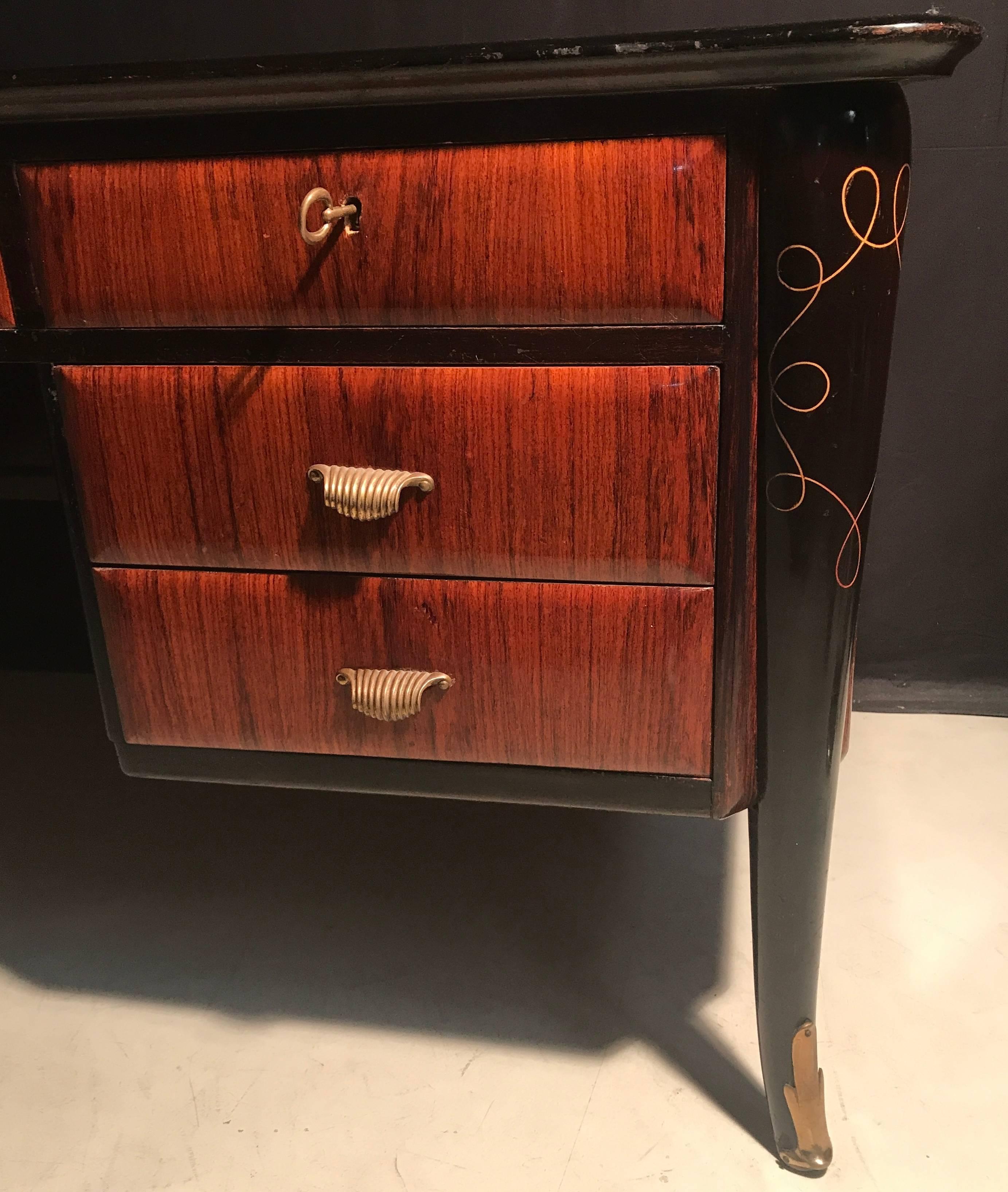 This stunning and impressive Italian executive desk with finished brass sabots and seven drawers.