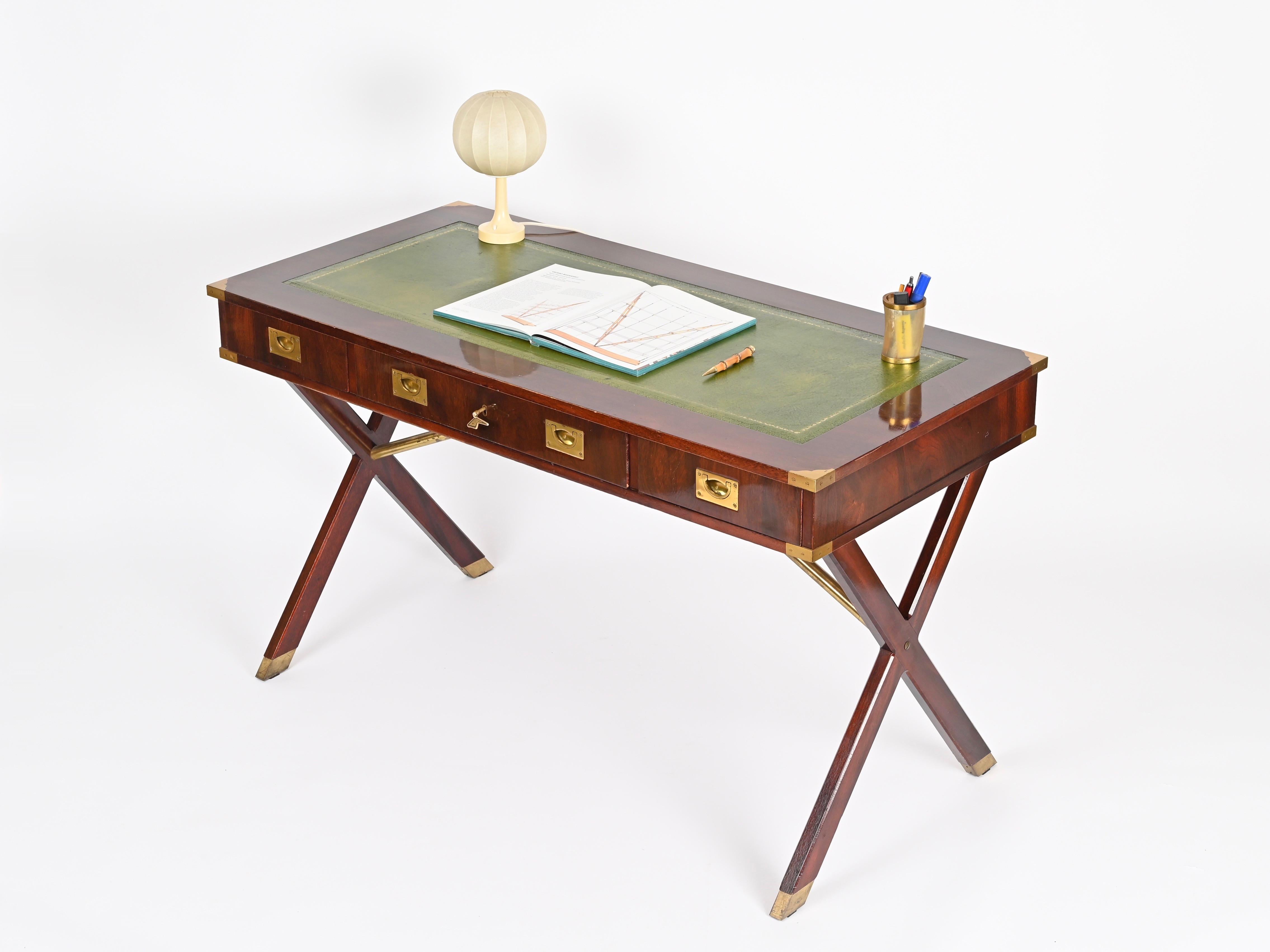 Stunning mid-century Italian military campaign desk in walnut with brass details and a  green leather top. This incredibly stylish and unique piece was crafted in Italy during the 1960. 

Completely original and in fantastic condition. The quality