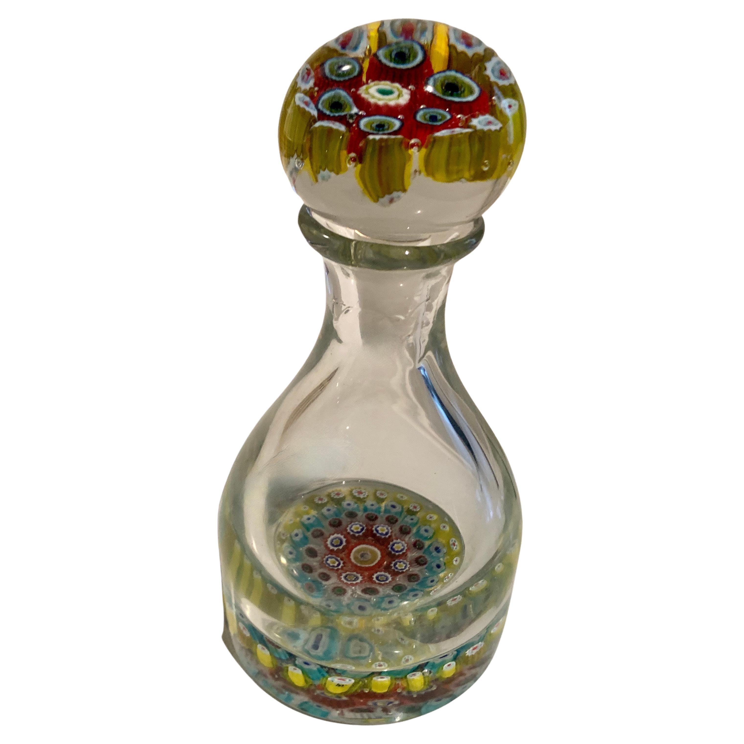 A Millefiori bottle. A wonderful hand crafted bottle with great color to the base and a complementary stopper. The bottle would work well for perfumes or as a decanter... hand blown and unique.